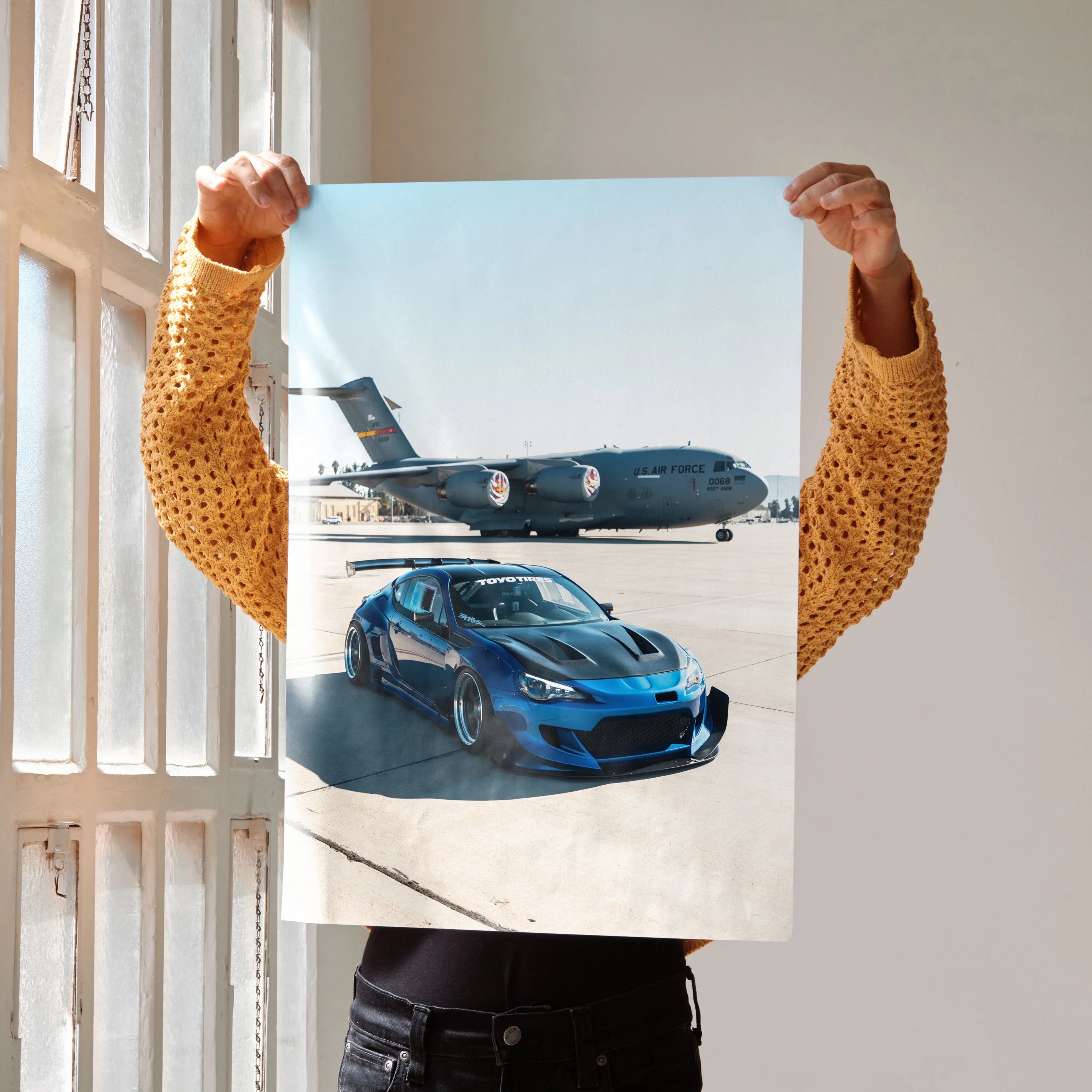 Toyota FRS poster wall art featuring blue sports car on runway with airplane background.