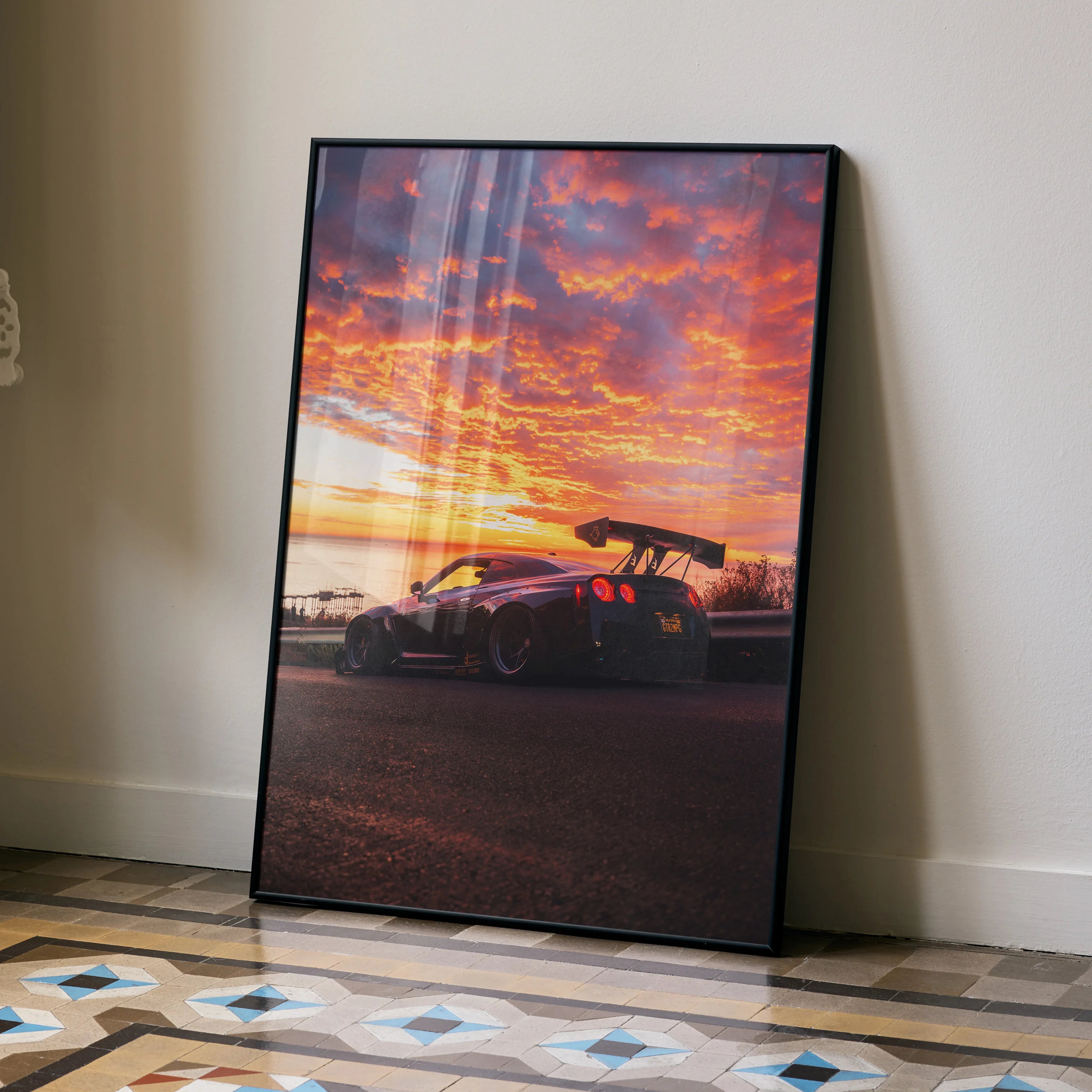 Nissan GT-R R35 Widebody poster with dramatic sunset sky, sleek car silhouette, modern wall art design.