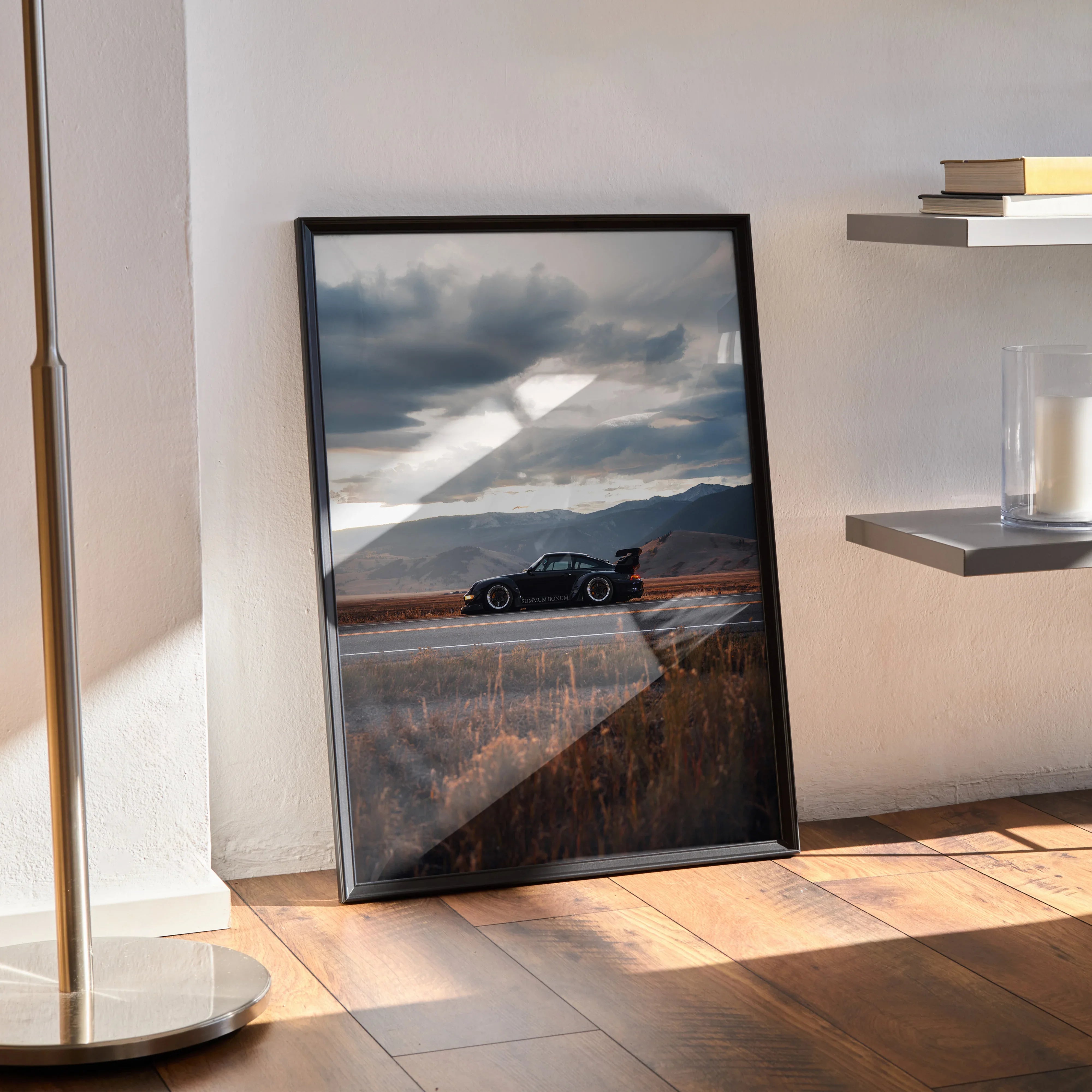 RWB Porsche 911 car poster with black frame leaning against wall, modern wall art with scenic mountain background.