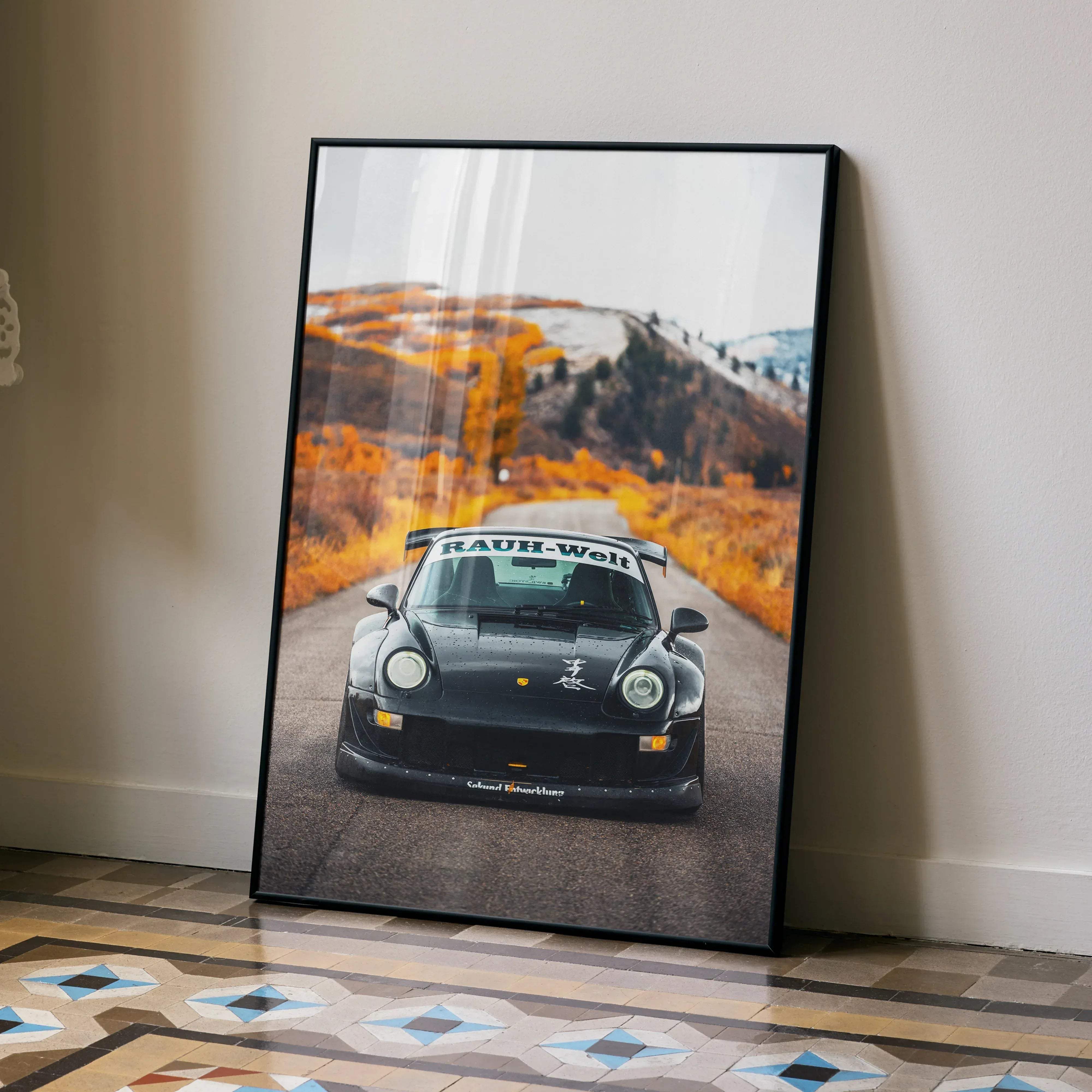 Black framed poster featuring a high resolution RWB Porsche 911 racing car with rauh-welt decals on windshield and bumper