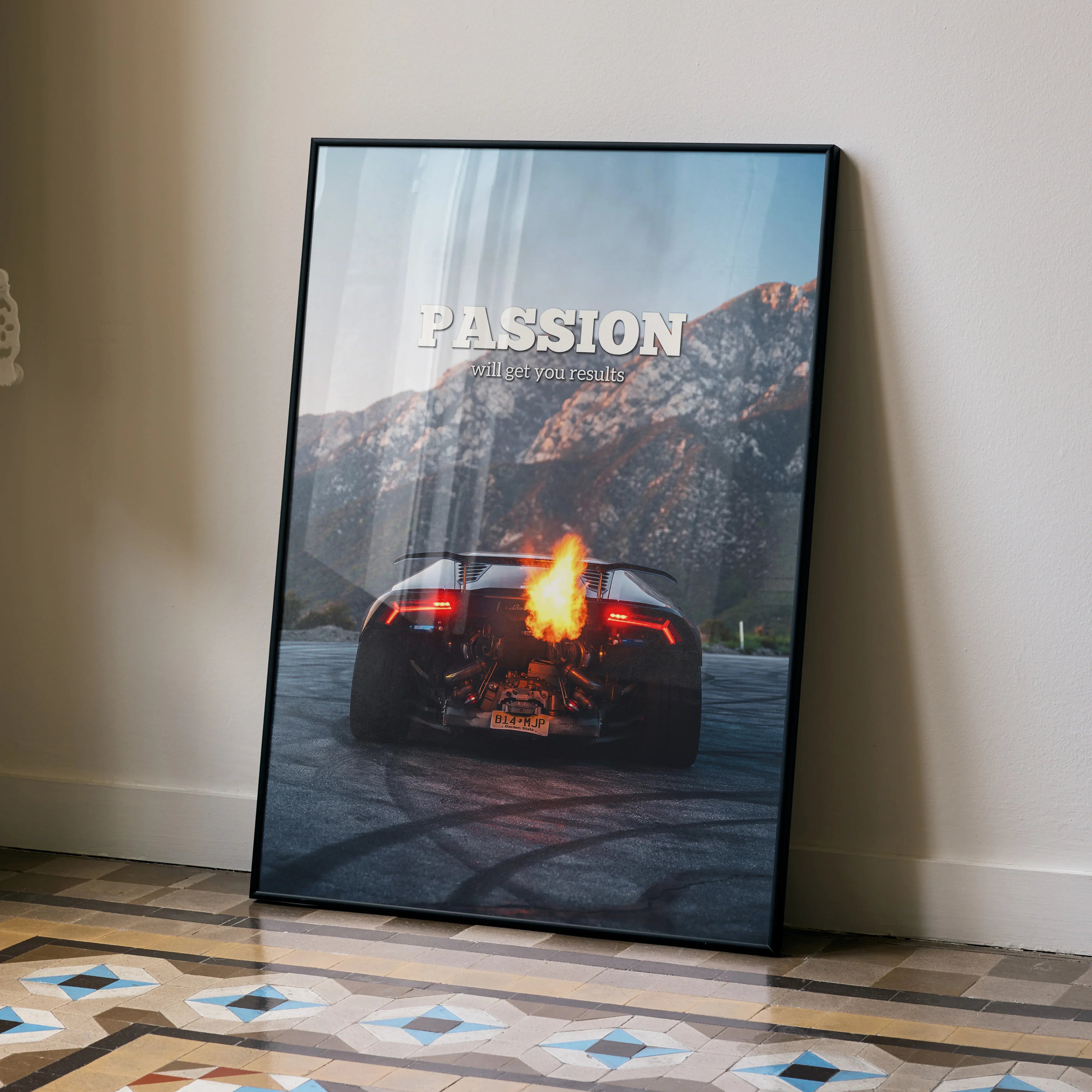 Motivational poster wall art featuring Lamborghini Huracan rear with flames and mountain background.