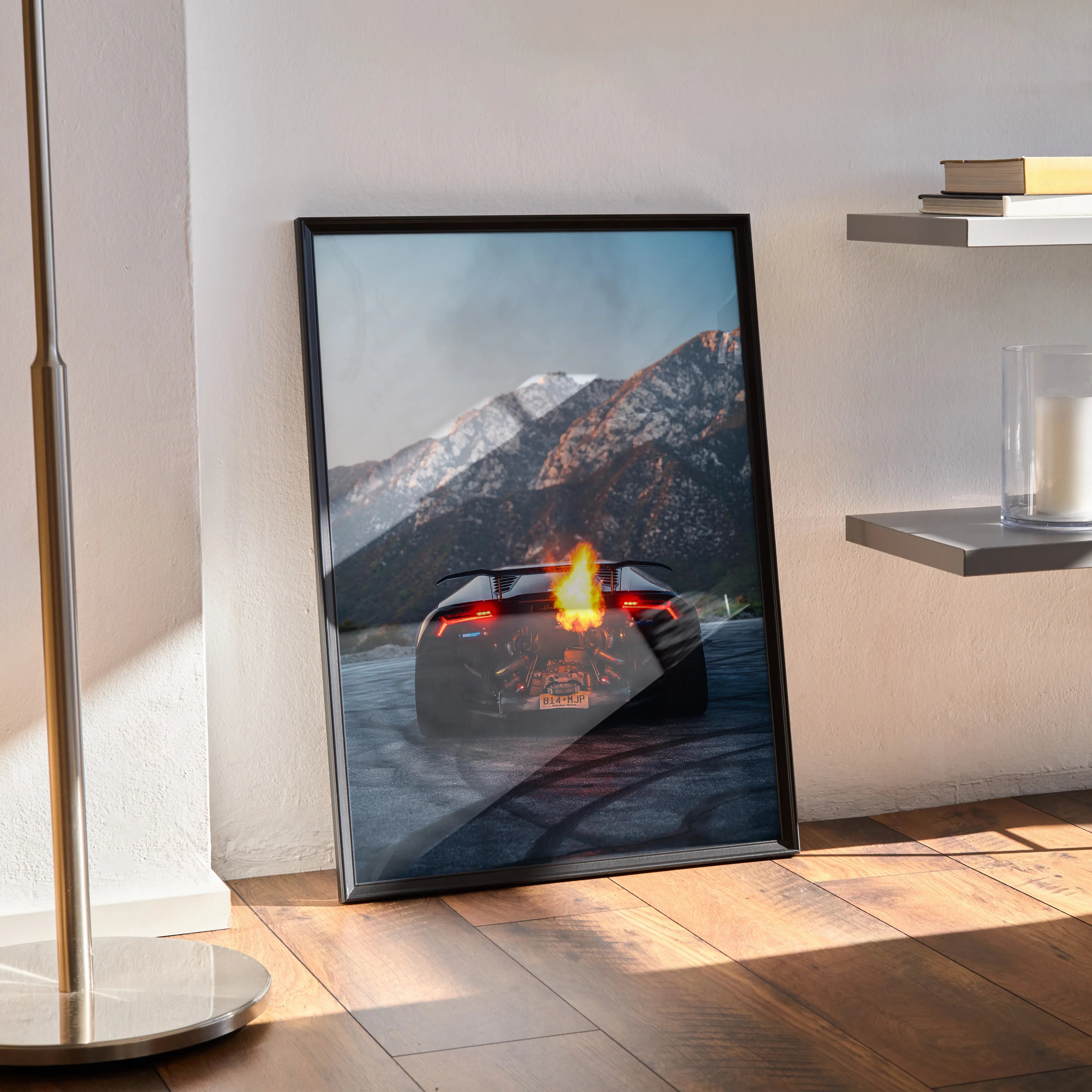Lamborghini Huracan poster with fiery flames on rear, set against snowy mountain wall art.