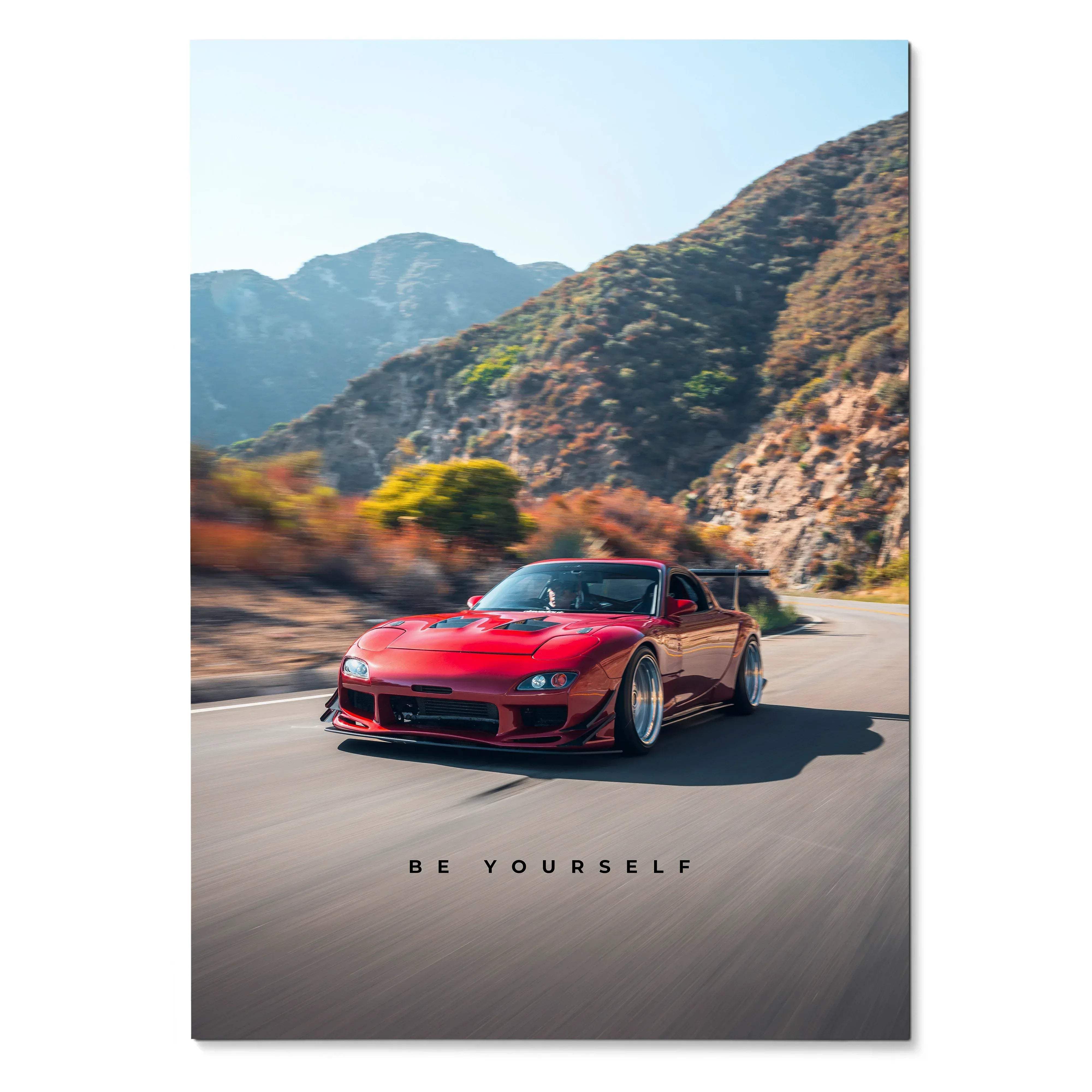 A vibrant red Mazda RX7 FD sports car with custom alloy wheels speeding on a winding mountain road motivational poster