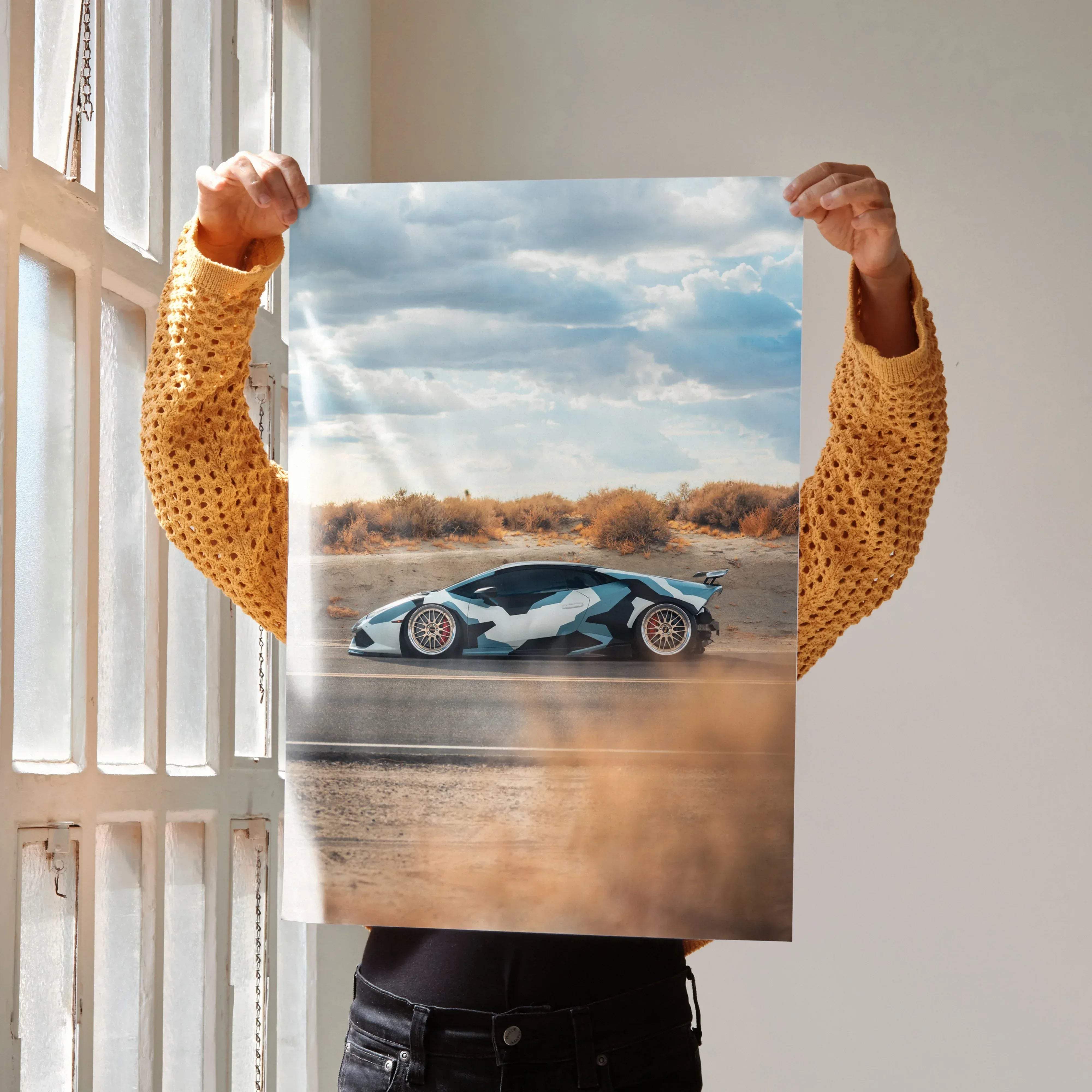 A vibrant blue and white Lamborghini Huracan high resolution car poster featuring a dynamic desert race scene