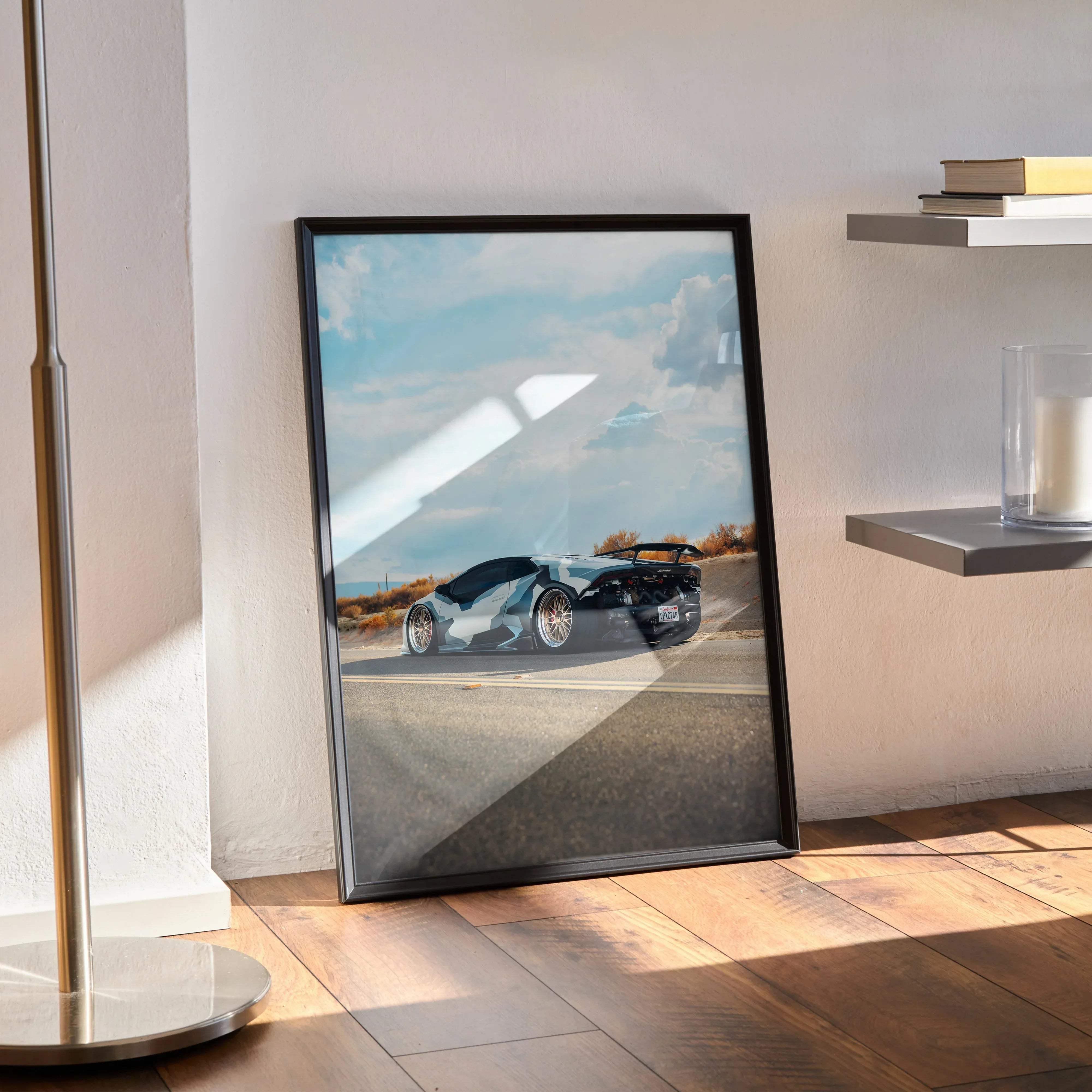 Black-framed Lamborghini Huracan high resolution poster of a sleek silver and black sports car with gold rims on road