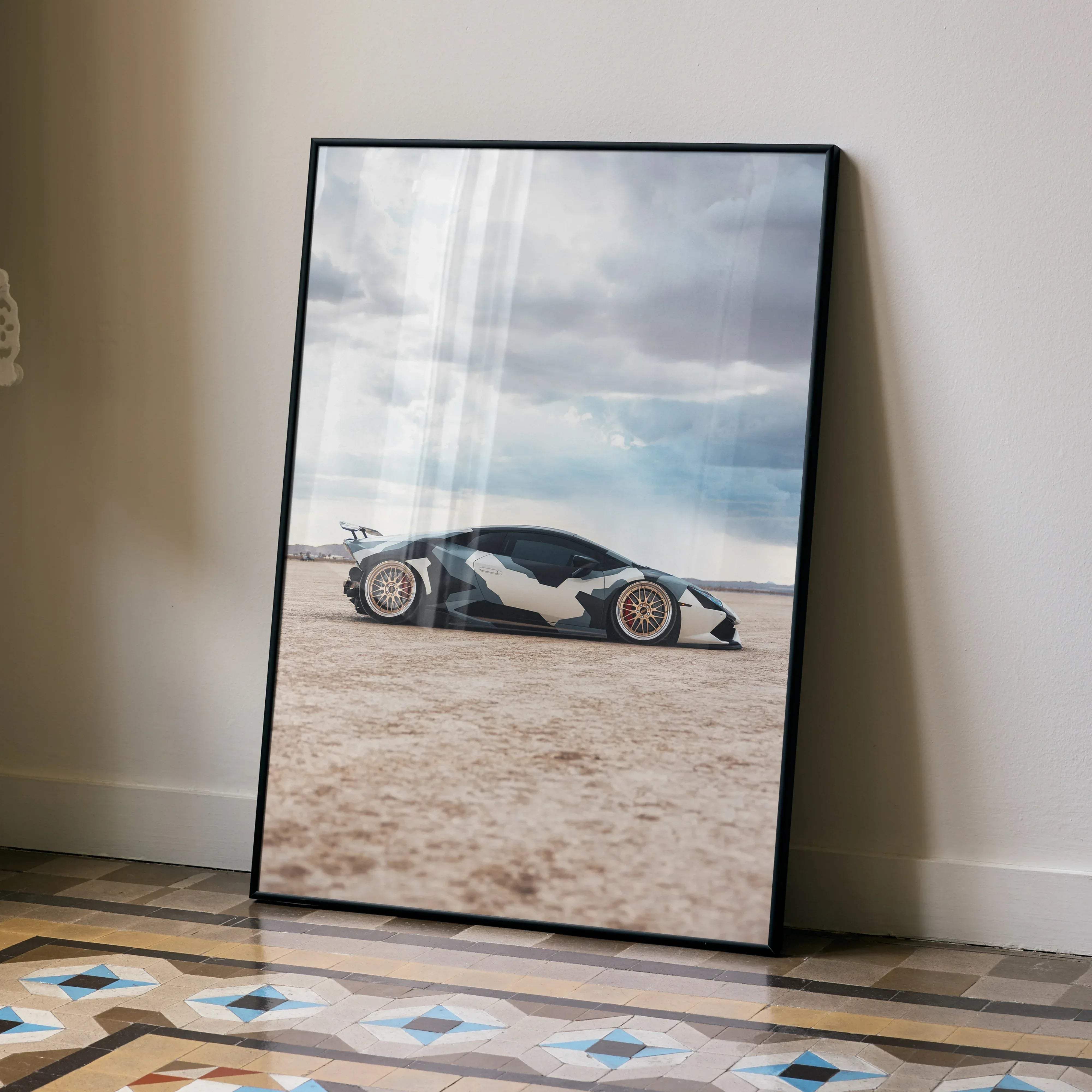 Black-framed Lamborghini Huracan high resolution car poster featuring white and dark gray geometric camouflage in desert