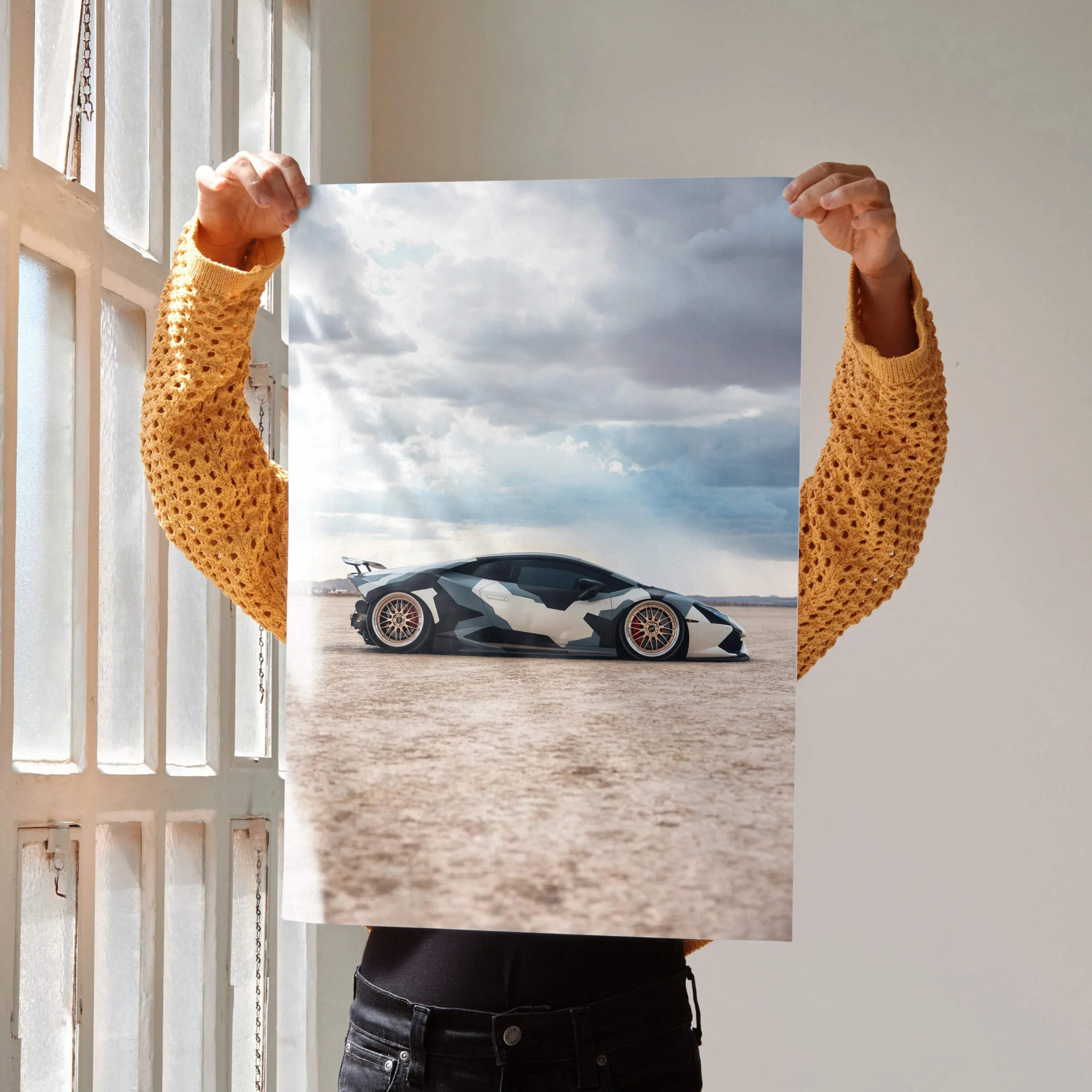 Lamborghini Huracan high resolution poster featuring a sleek matte black and white camouflage car with desert storm backdrop
