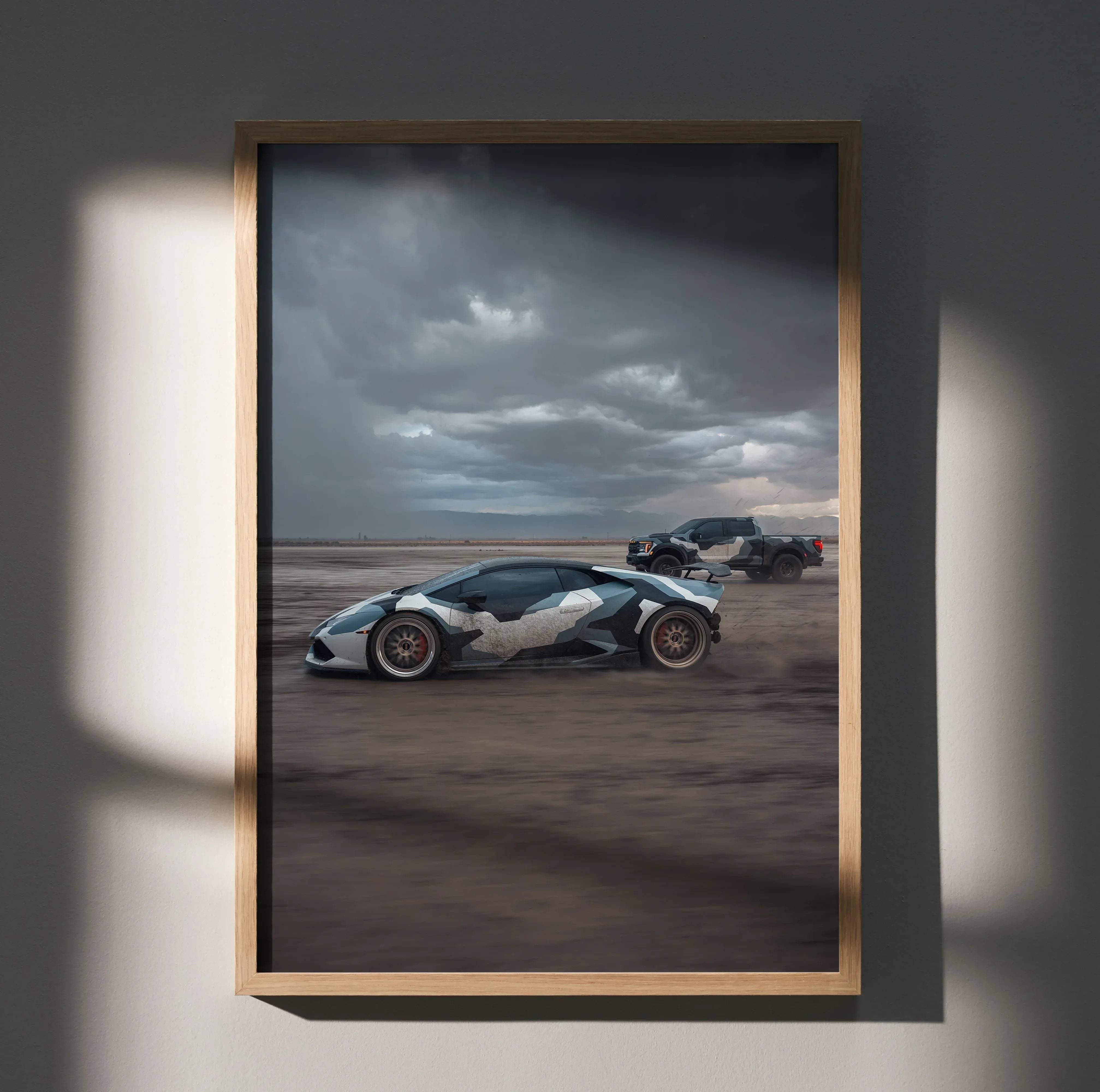 A framed poster of a white and black camouflage Lamborghini Huracan with red brake calipers in a desert setting