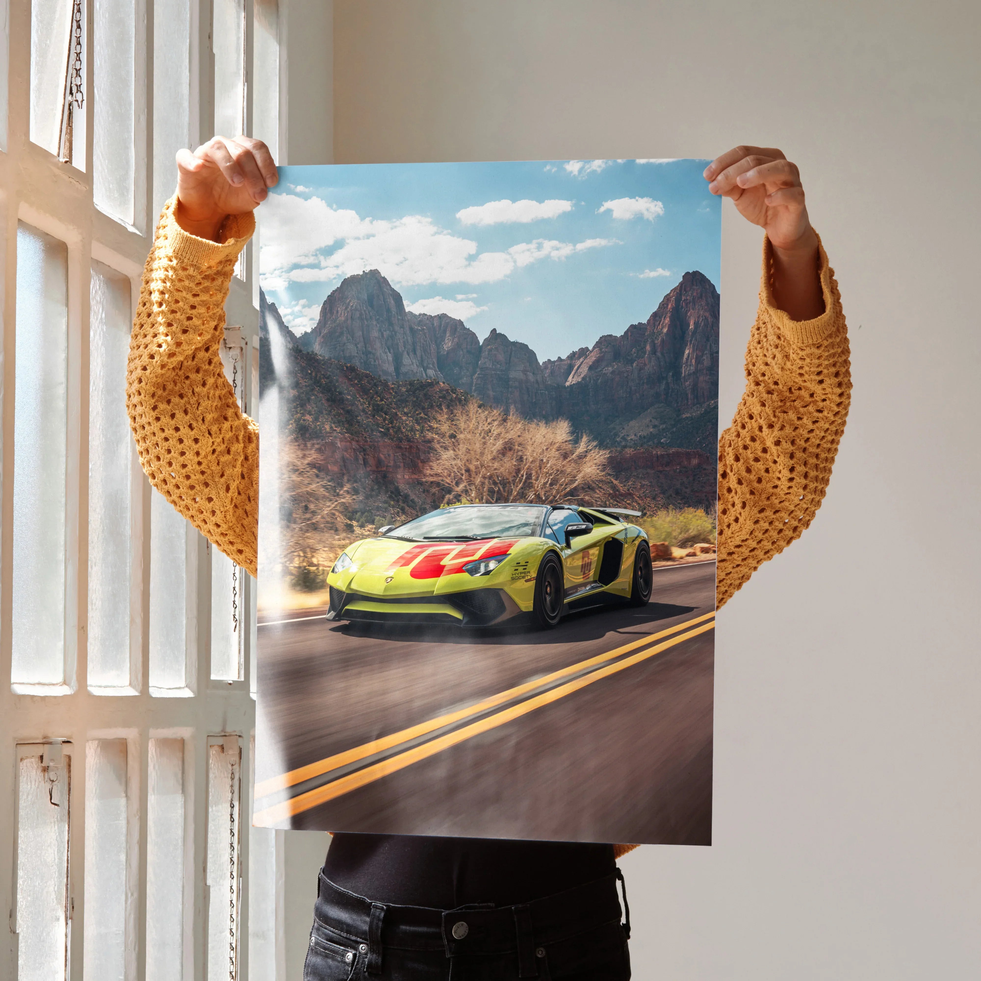 Lamborghini Aventador SVJ driving on mountain road poster wall art with blue sky background.
