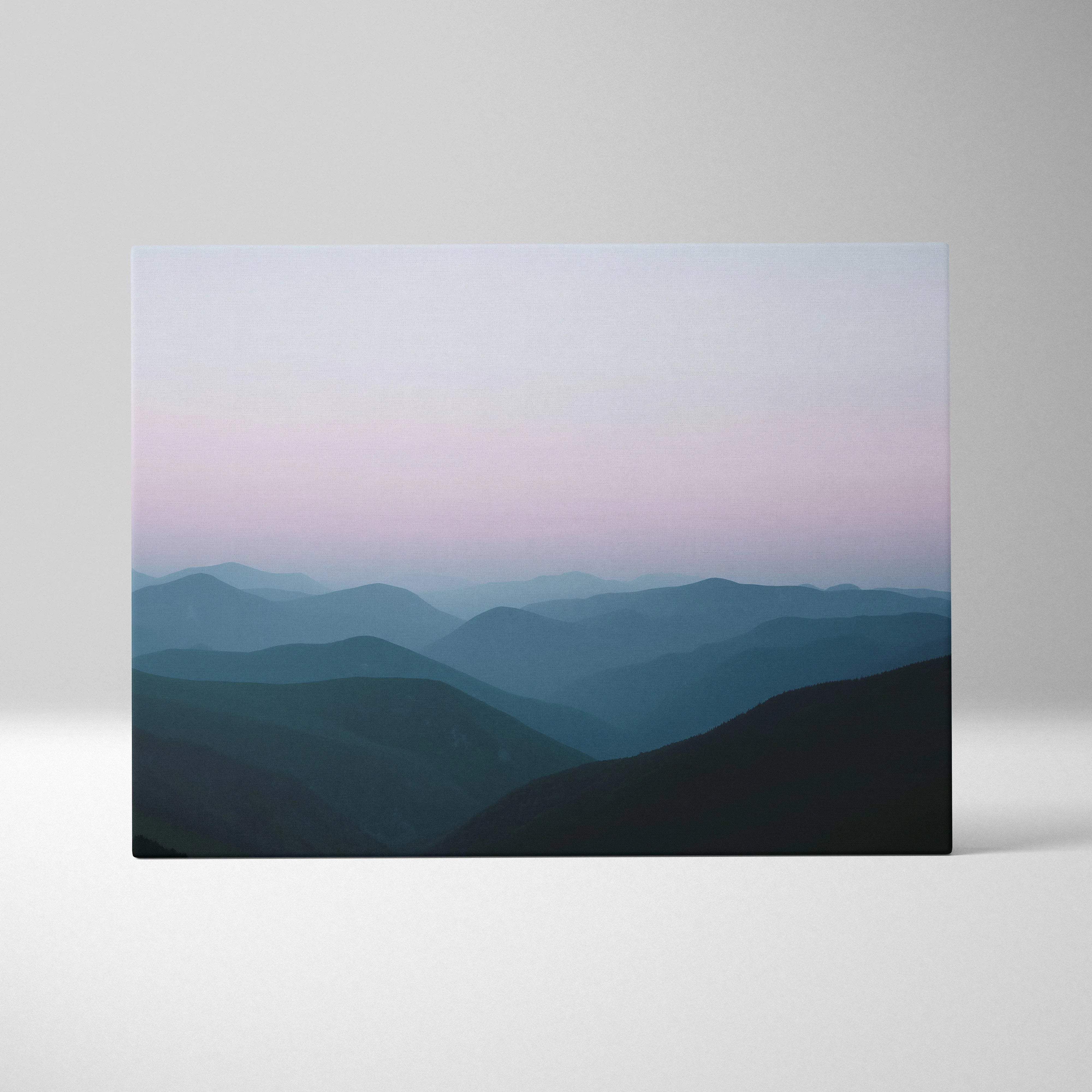 Canvas print of foggy morning mountains in soft pink blue gradient sky