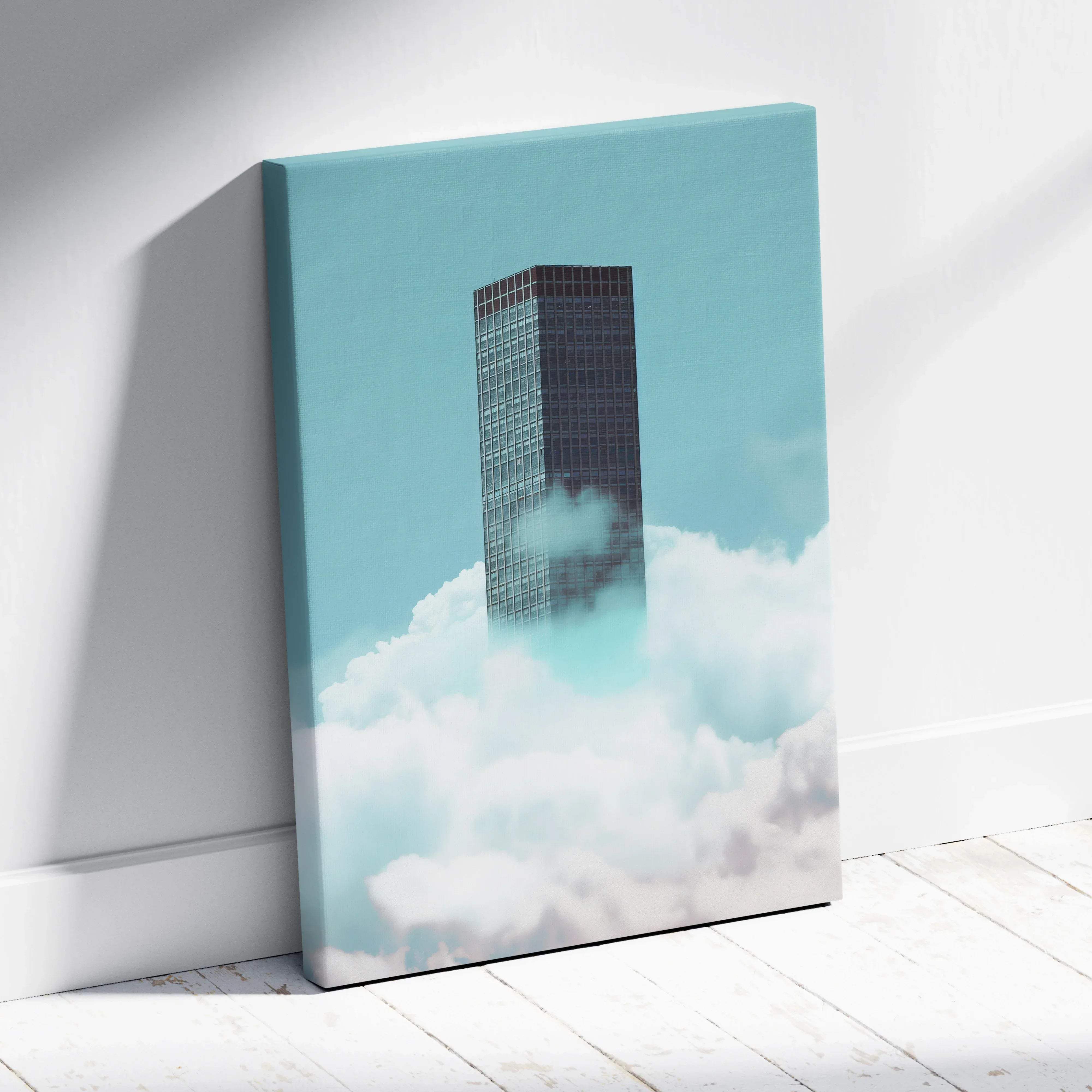 A modern minimalist canvas print of a dark glass skyscraper in white clouds with a teal calm tone for living room decor