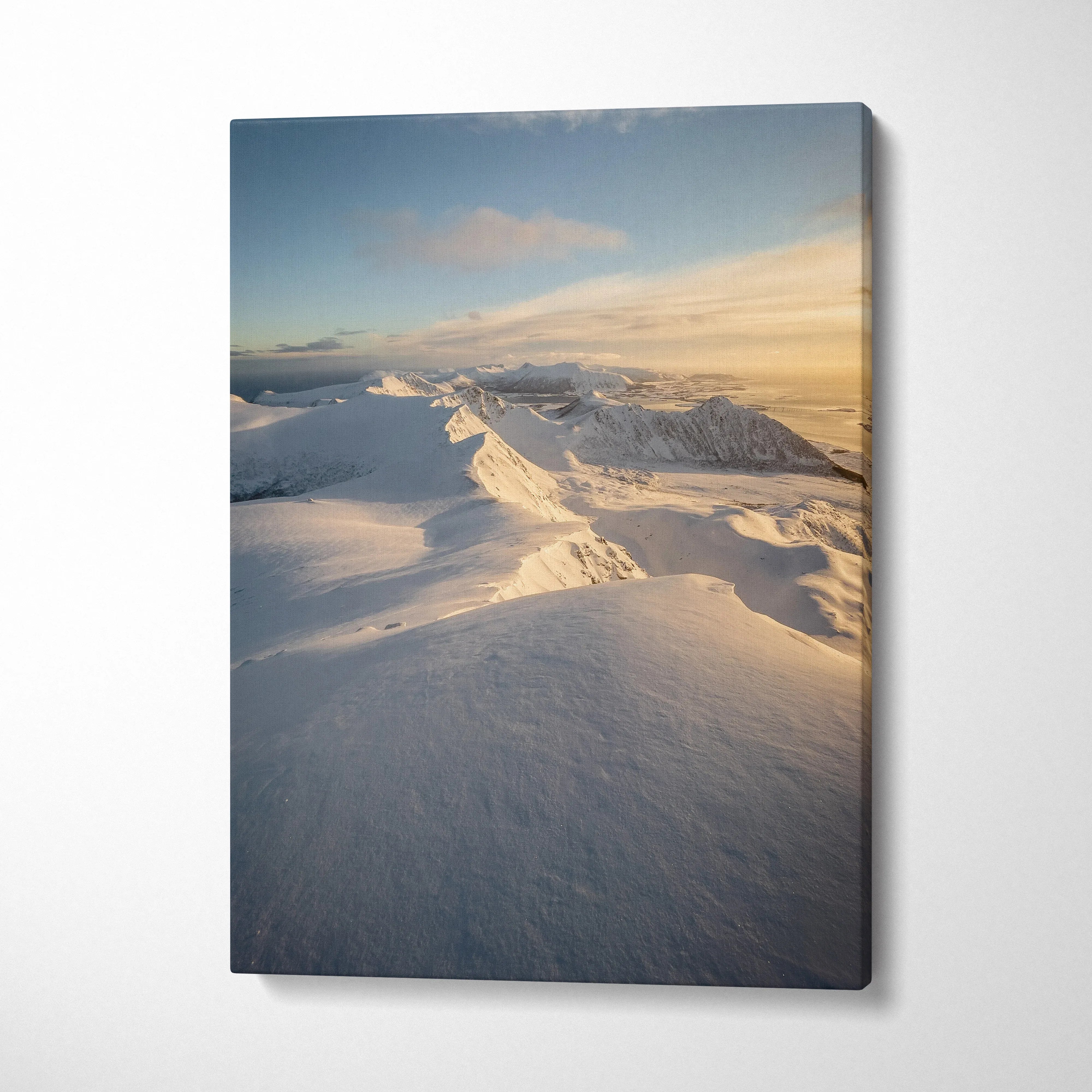 Canvas wall art featuring majestic snowy mountains under soft golden light, winter decor.
