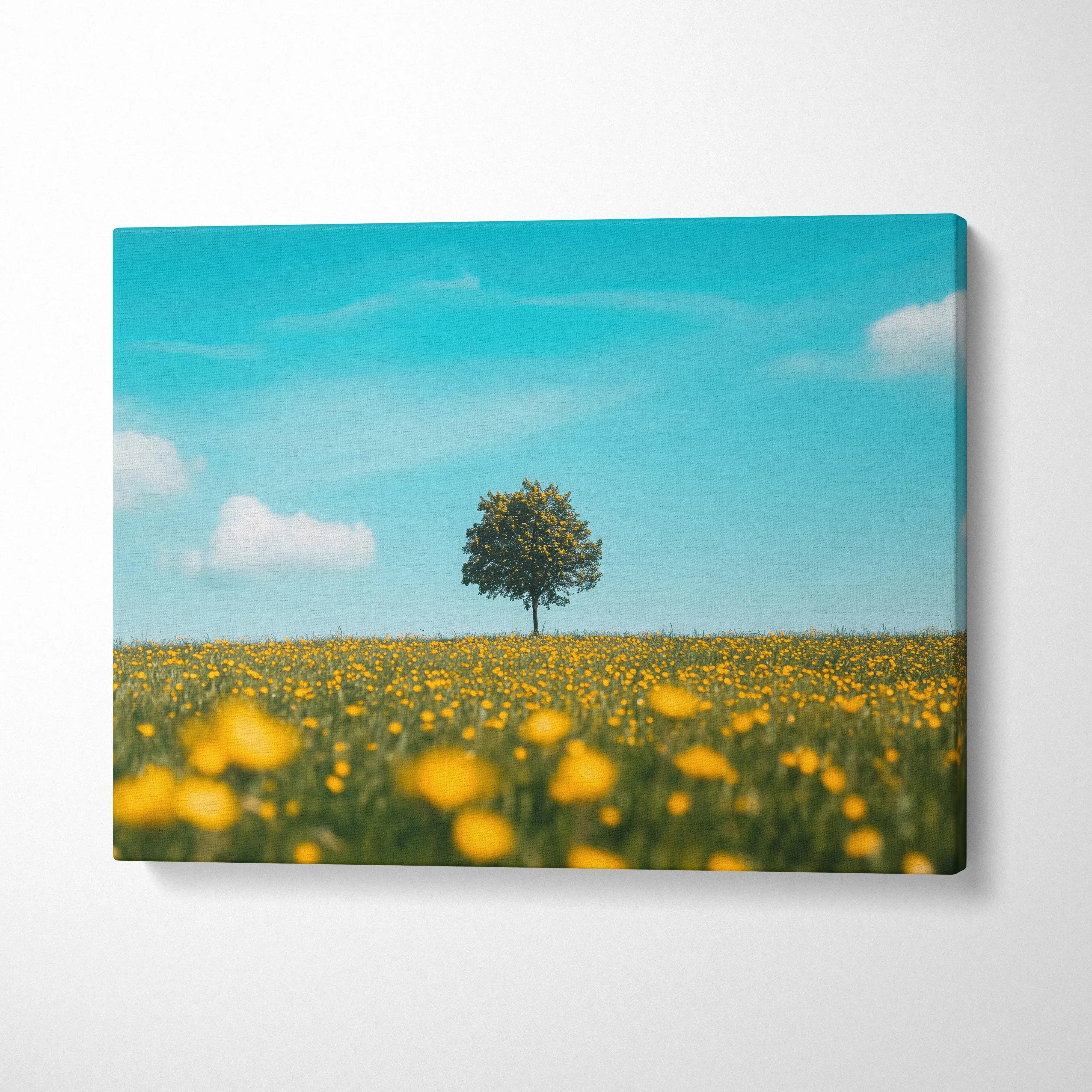 Canvas wall art featuring a solitary tree in a blooming yellow floral meadow under a bright blue sky.