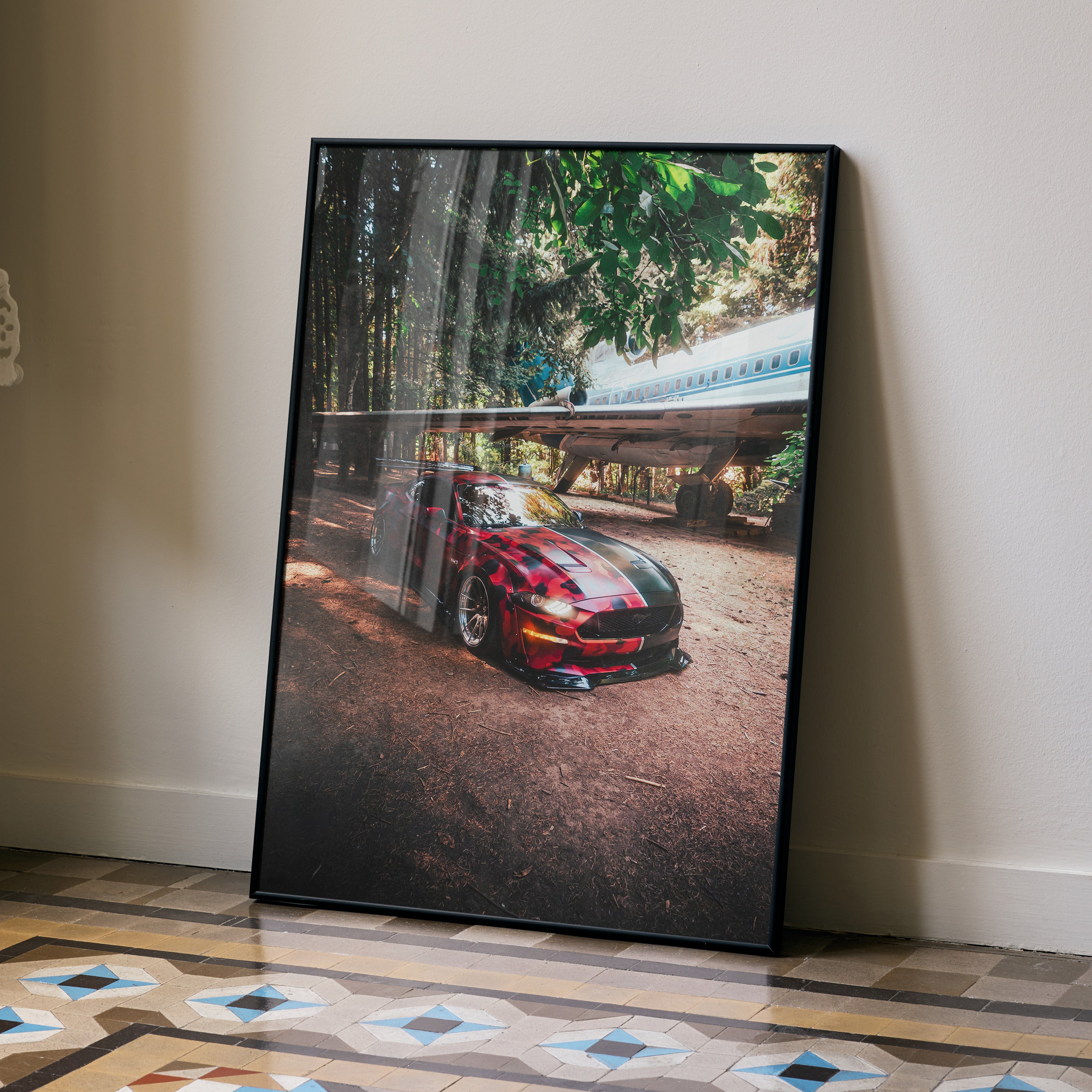 Ford Mustang S550 poster with red car under trees, sleek automotive wall art in black frame.