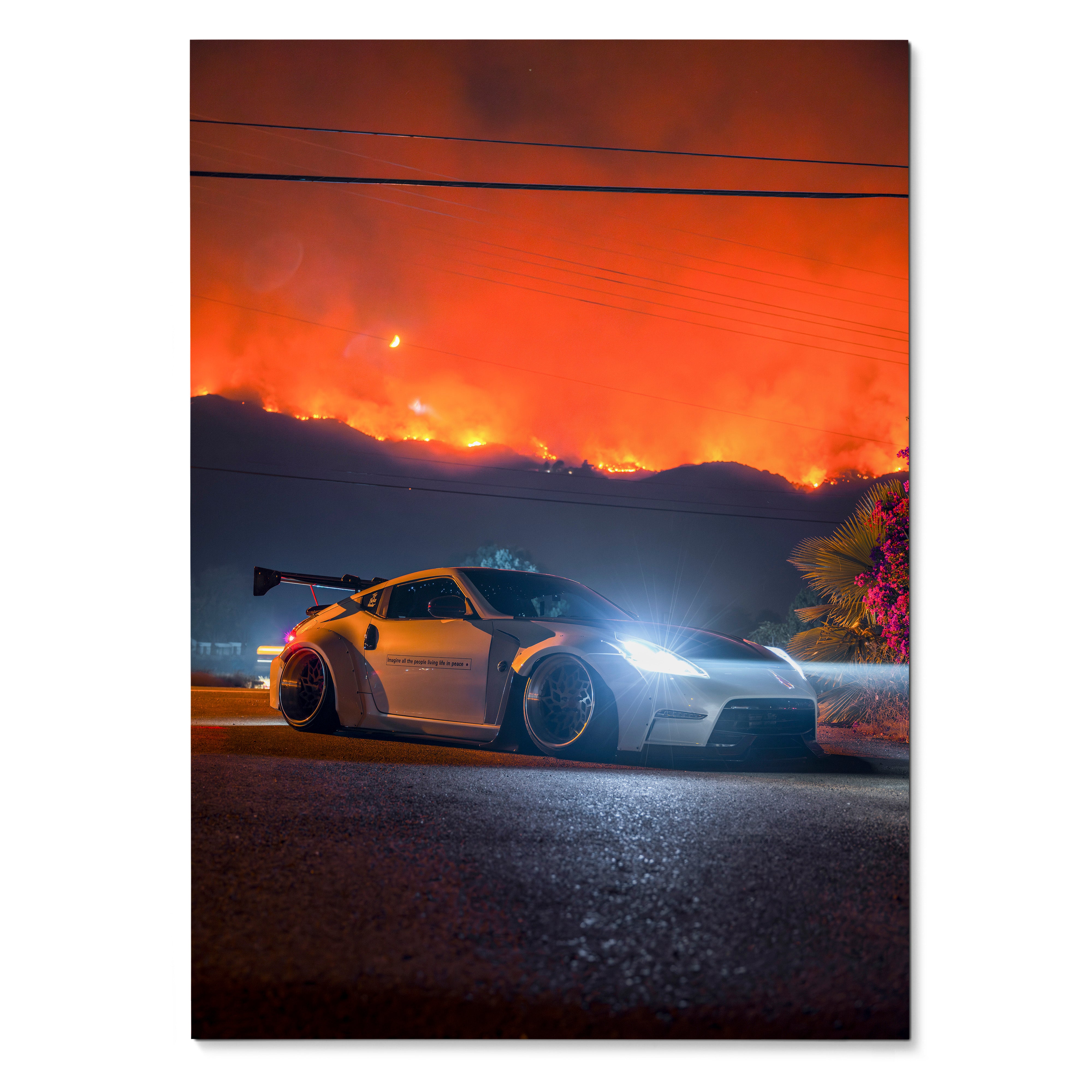 Nissan 370z sports car with wide body kit and glowing headlights against fiery orange sky poster wall art.
