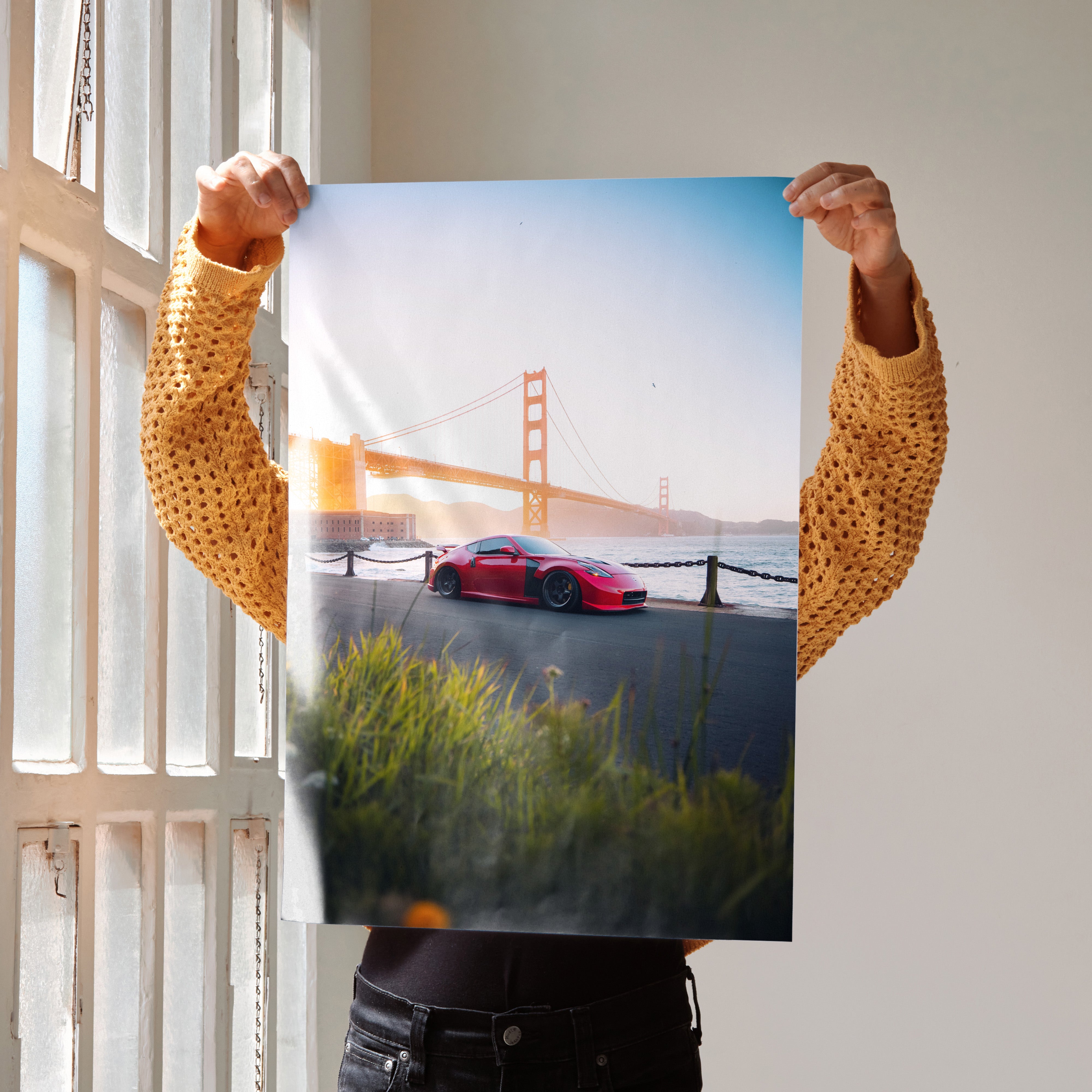 Nissan 370z poster wall art with red car at sunset near Golden Gate Bridge.