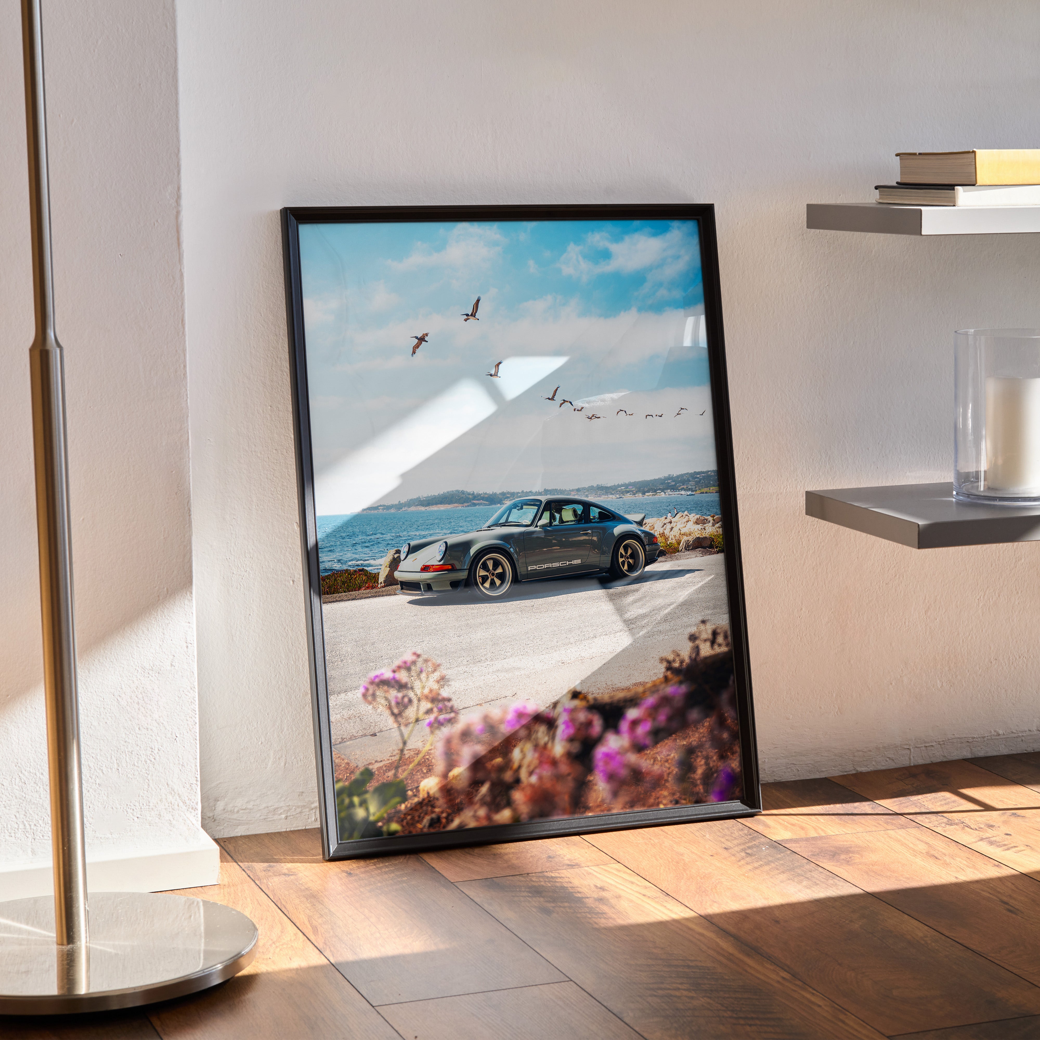 Porsche 911 classic car poster wall art with coastal road and blue sky in black frame.