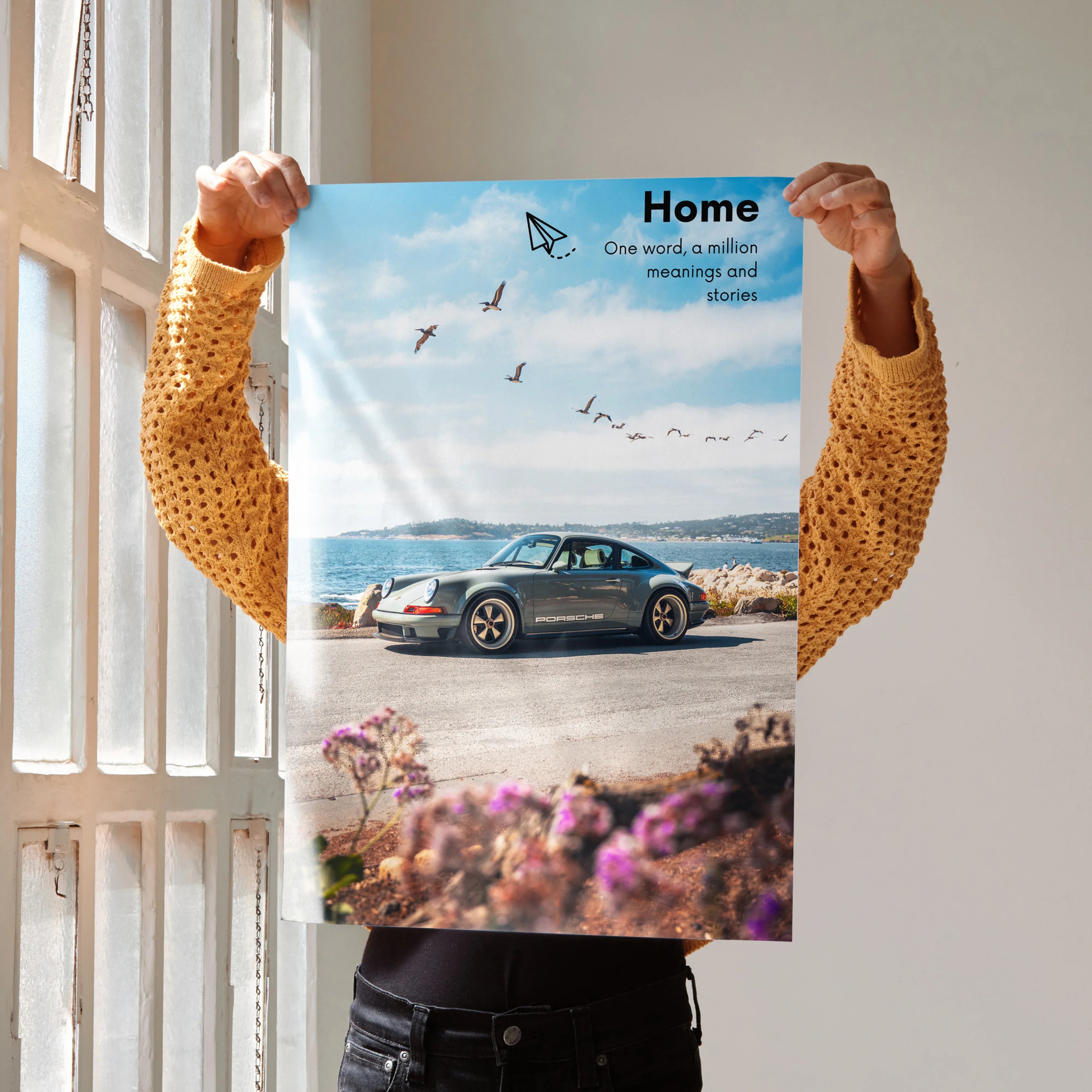 Motivational poster wall art featuring a classic Porsche 911 on a coastal road with inspiring text and birds in a blue sky.