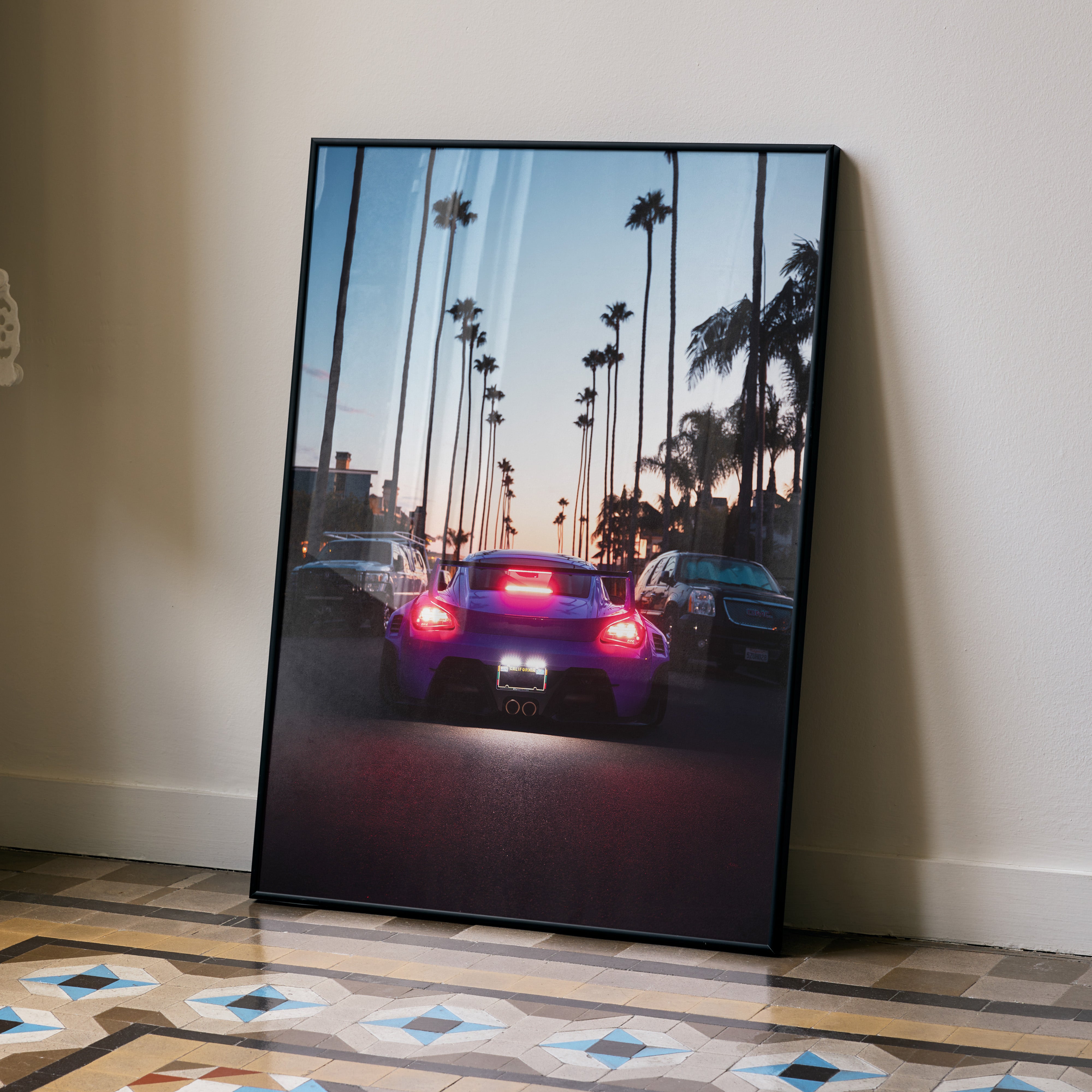 Porsche Cayman car poster with sunset and palm trees, stylish wall art in vibrant colors.