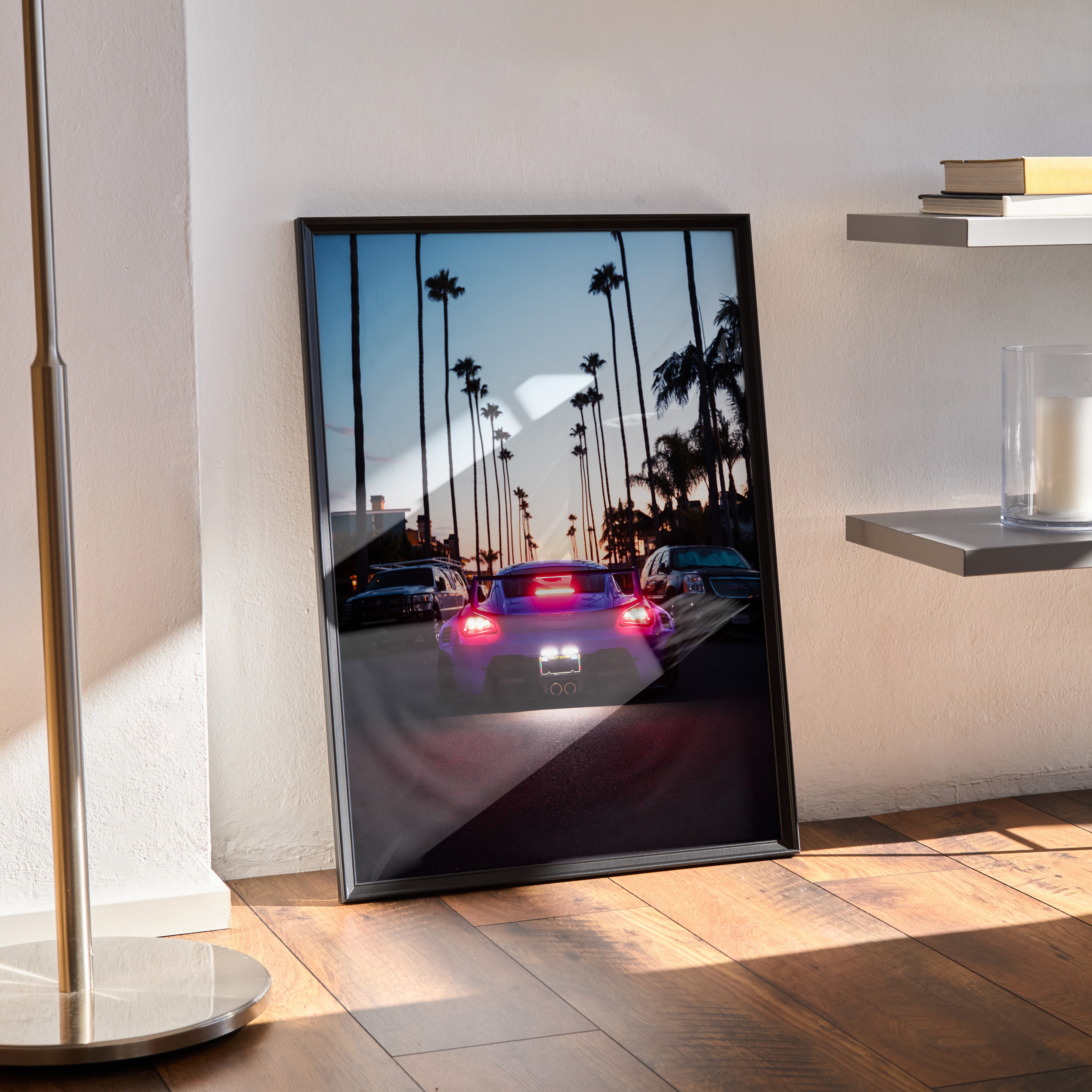 Porsche Cayman car poster with palm trees at sunset, vibrant wall art in black frame.