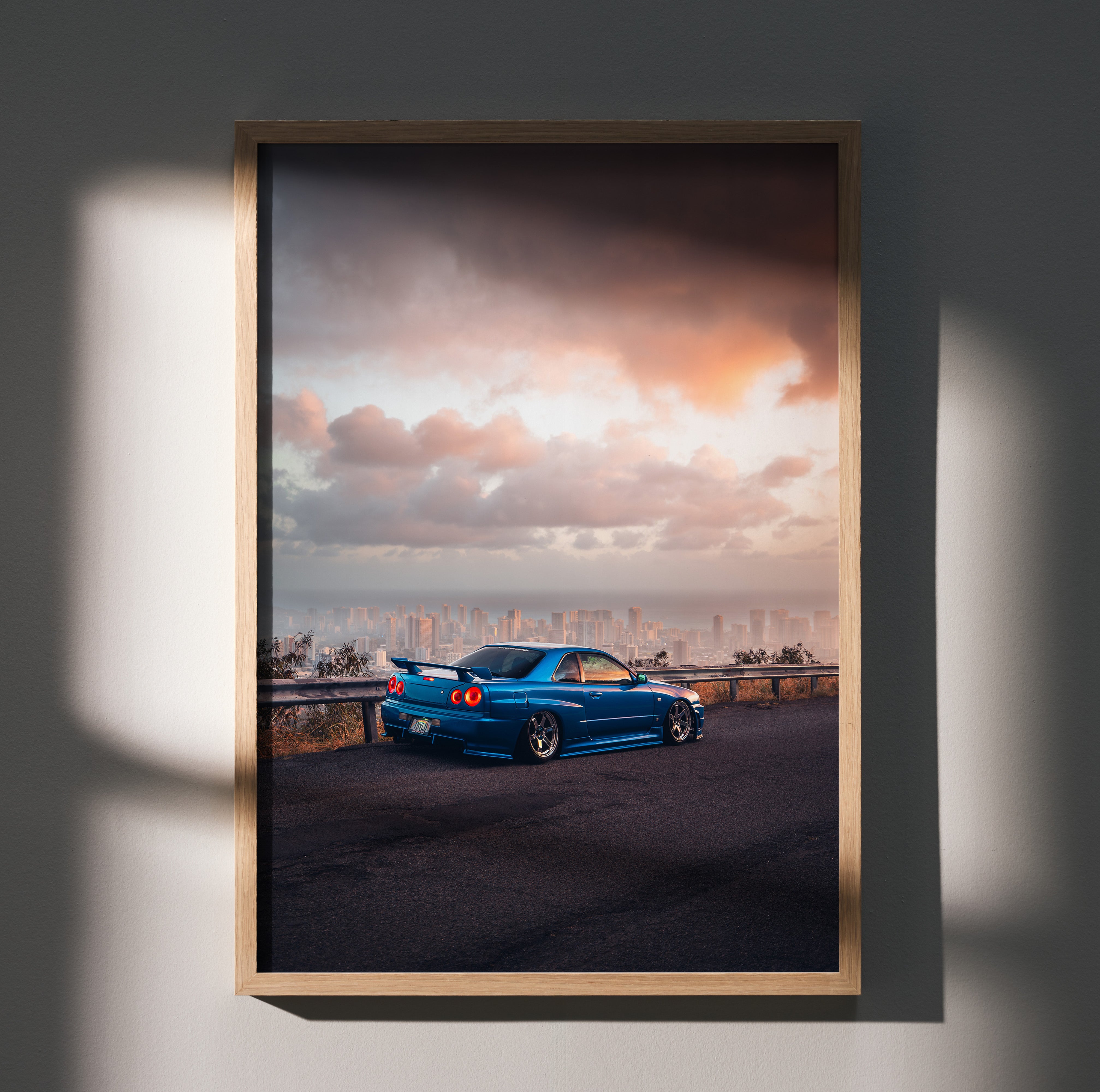Nissan Skyline GTR R34 poster wall art with blue car under moody sunset sky.
