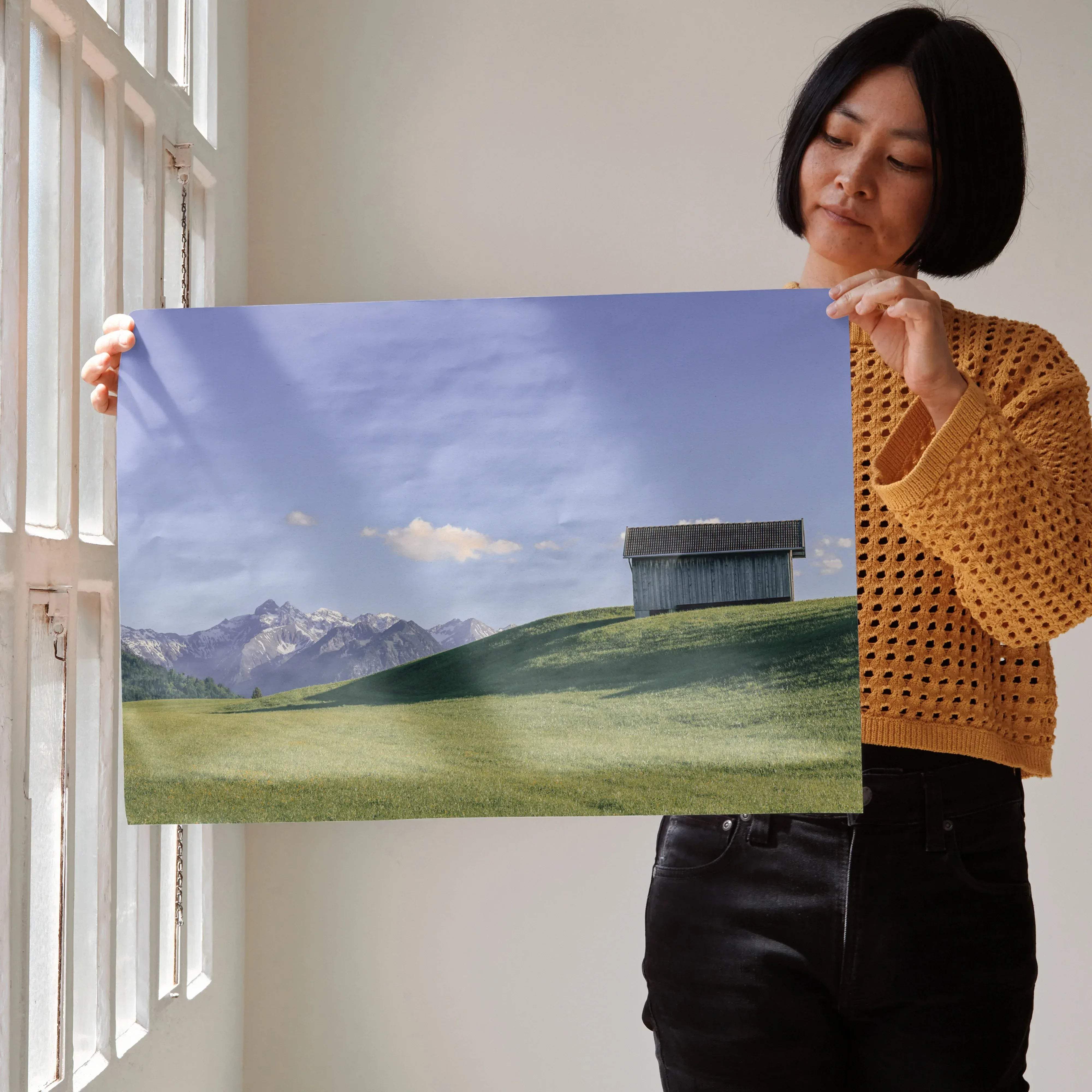 Majestic mountain nature art poster featuring a dark wooden barn on a green hill with snow-capped mountains background