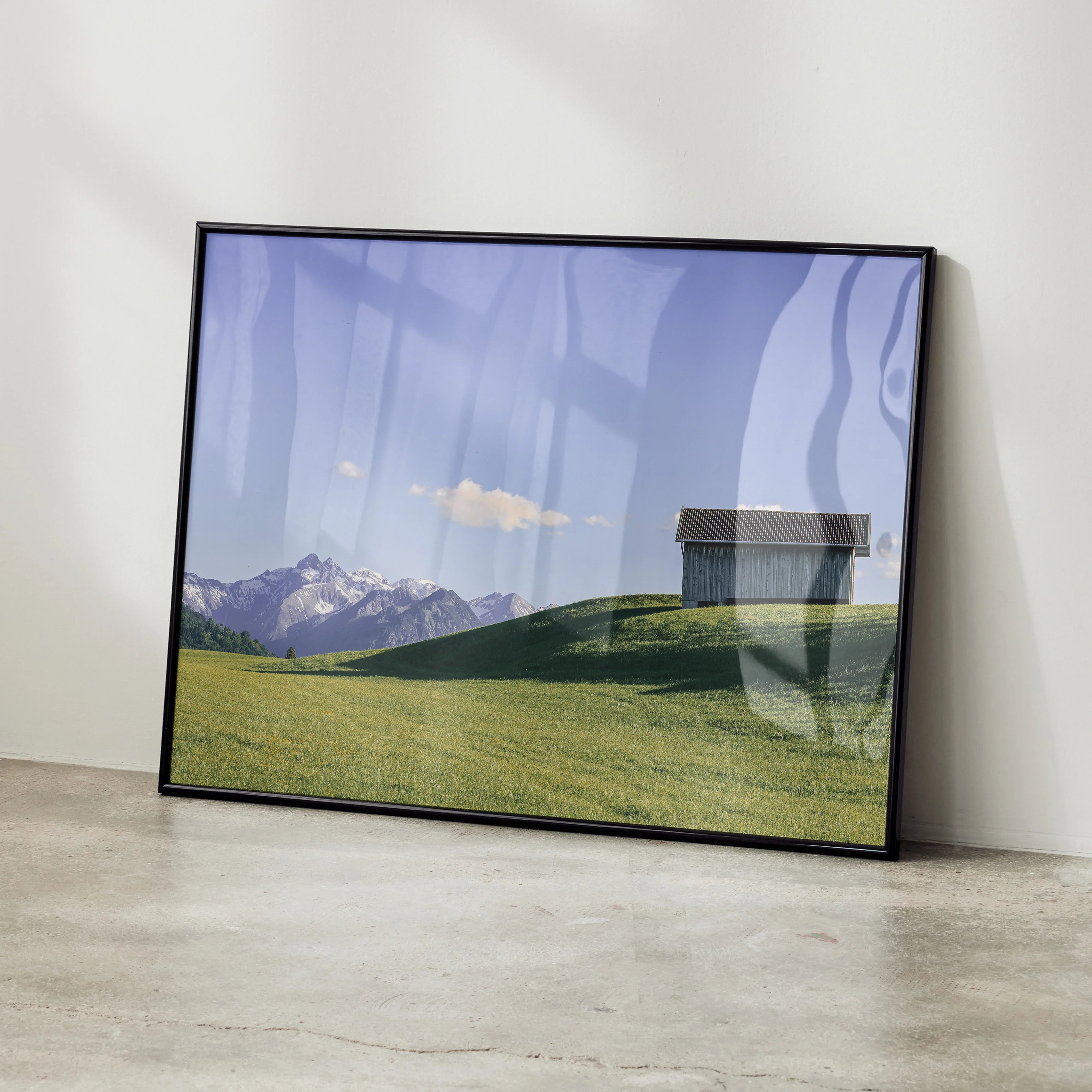 Majestic mountain landscape poster with green hills and blue sky wall art in black frame.