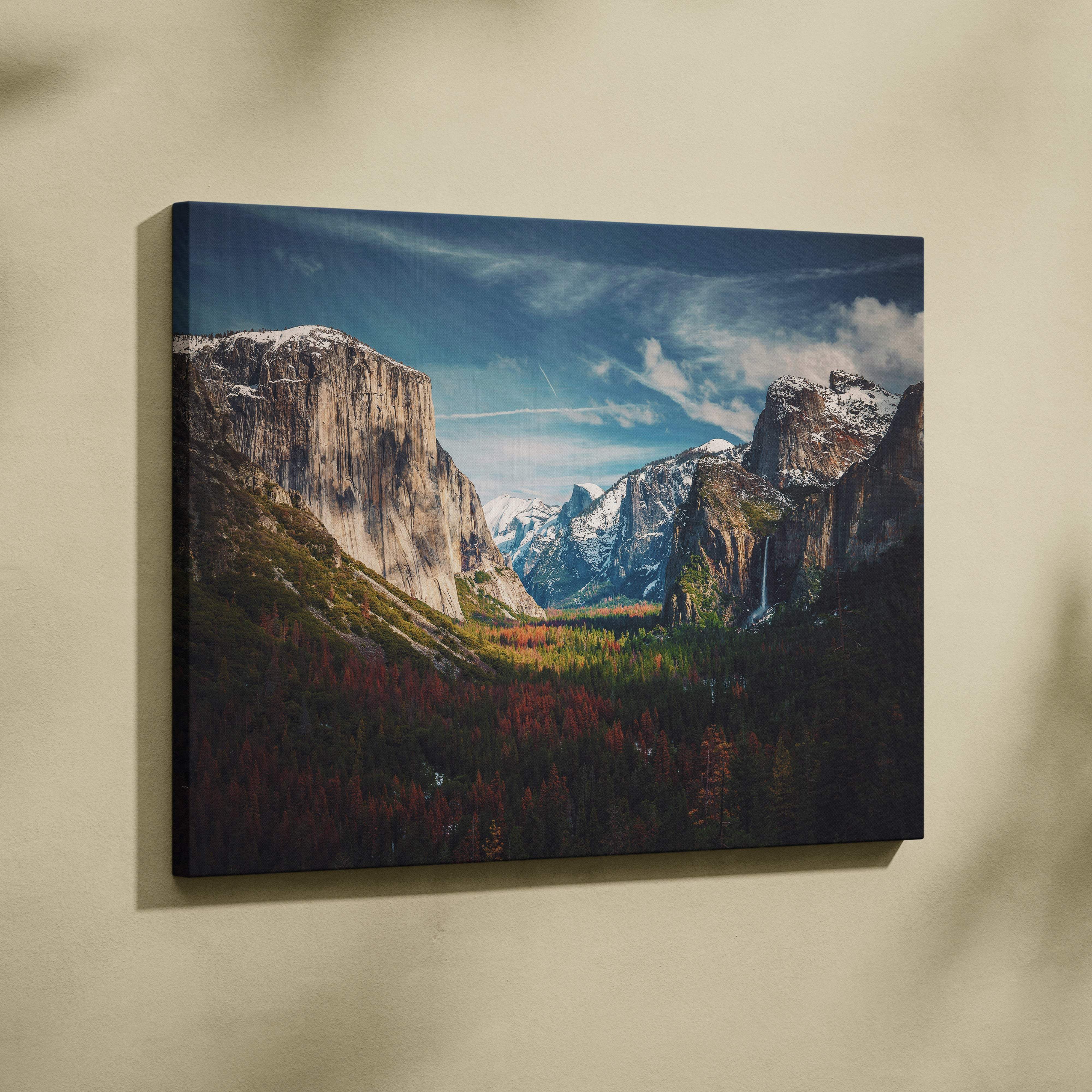 A framed canvas wall art print of yosemite valley mountain landscape with snow-capped peaks and autumn forests