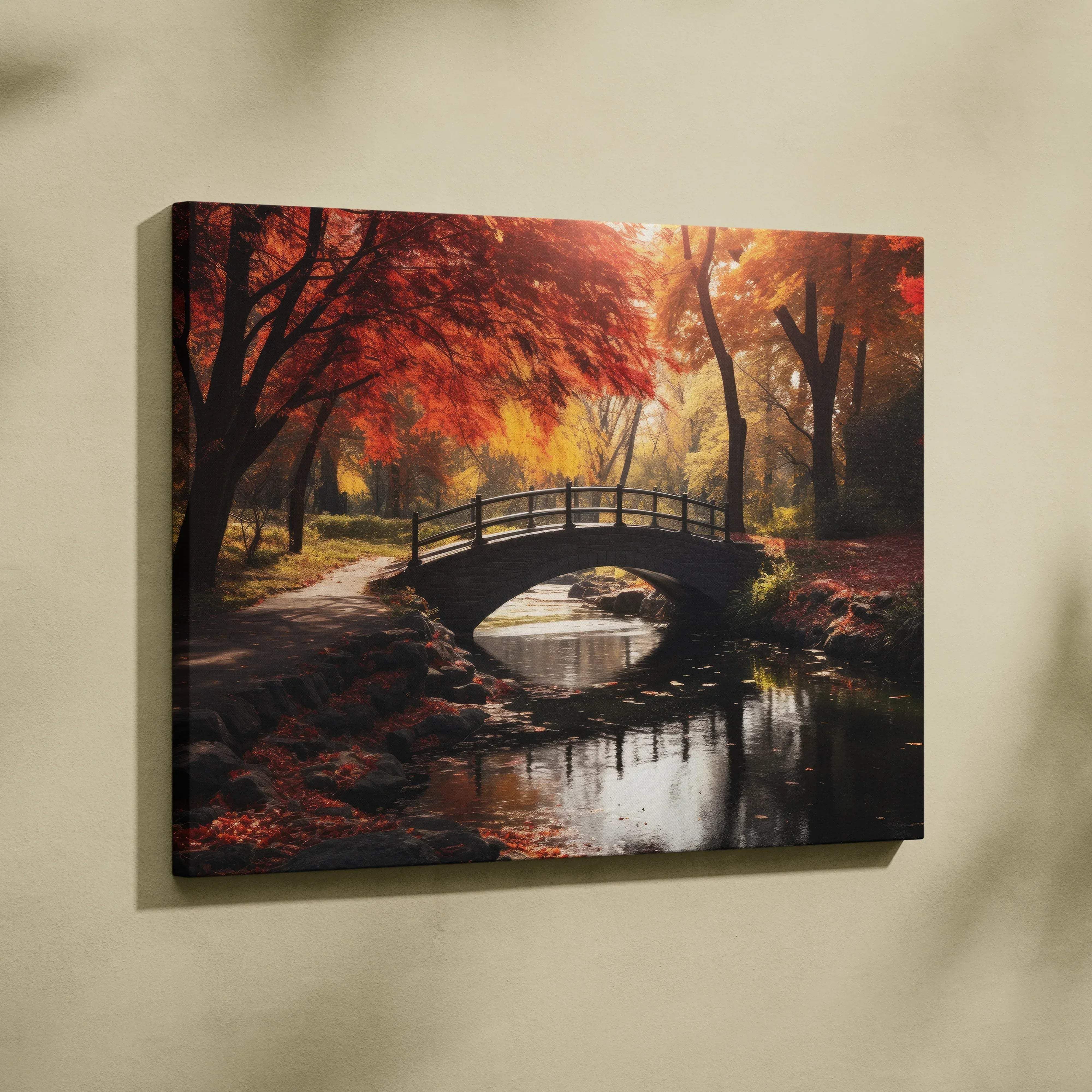 Canvas print of a serene autumn scene with vibrant red and orange maple trees over a stone bridge and calm stream