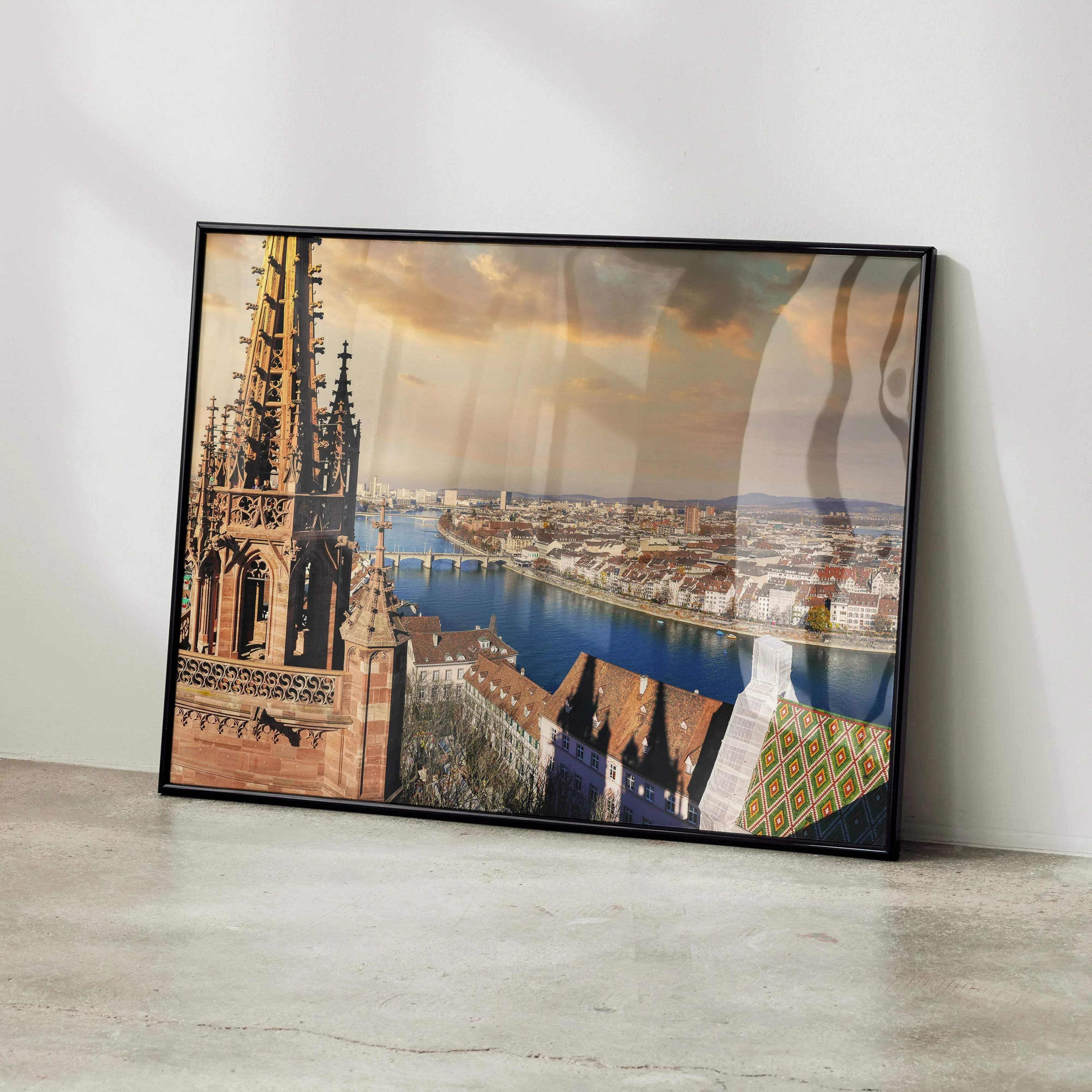 Black-framed stunning sunset cityscape building wall art poster featuring river historic red-tiled roofs and cathedral spire