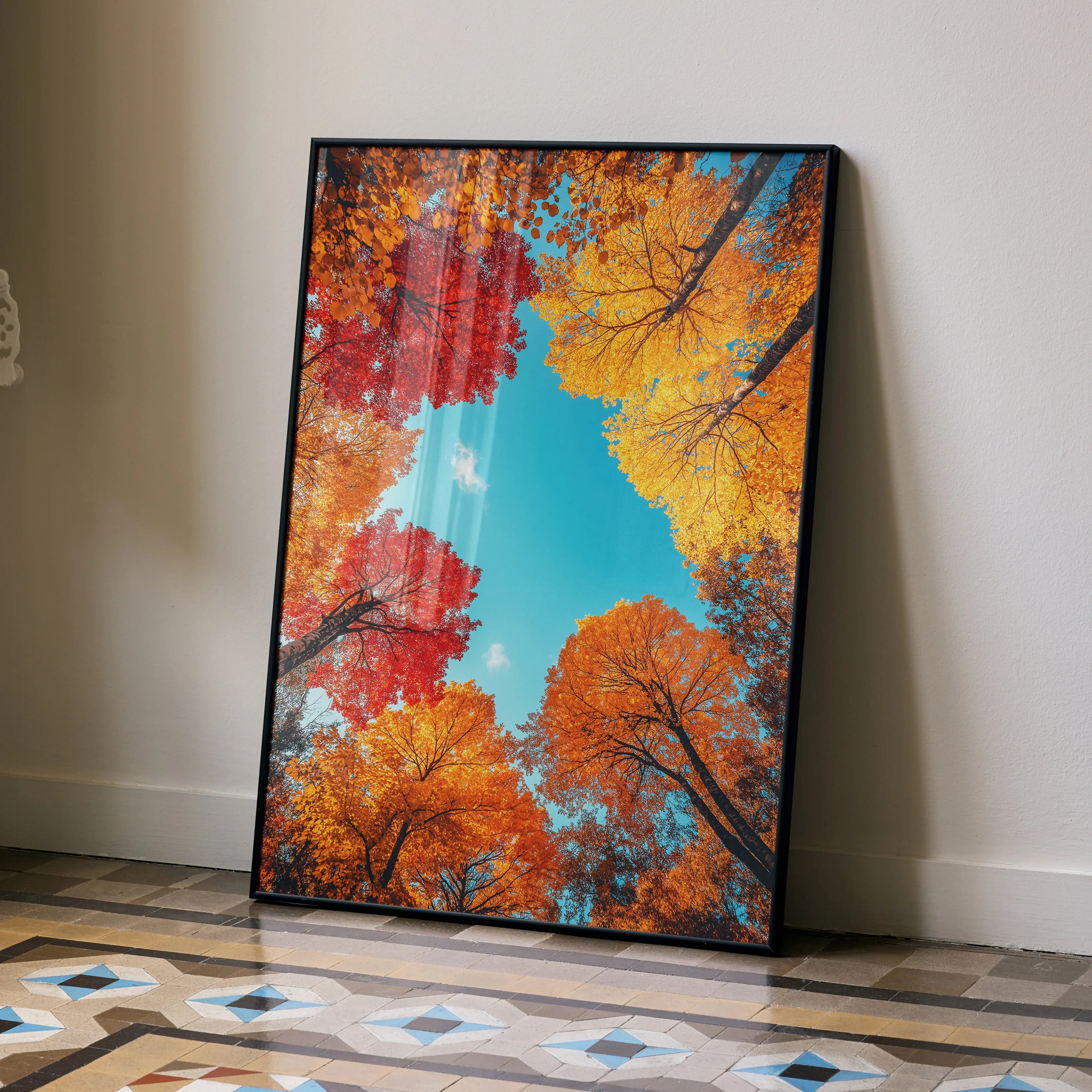 Vibrant autumn forest poster with bright orange and red foliage against a blue sky wall art.