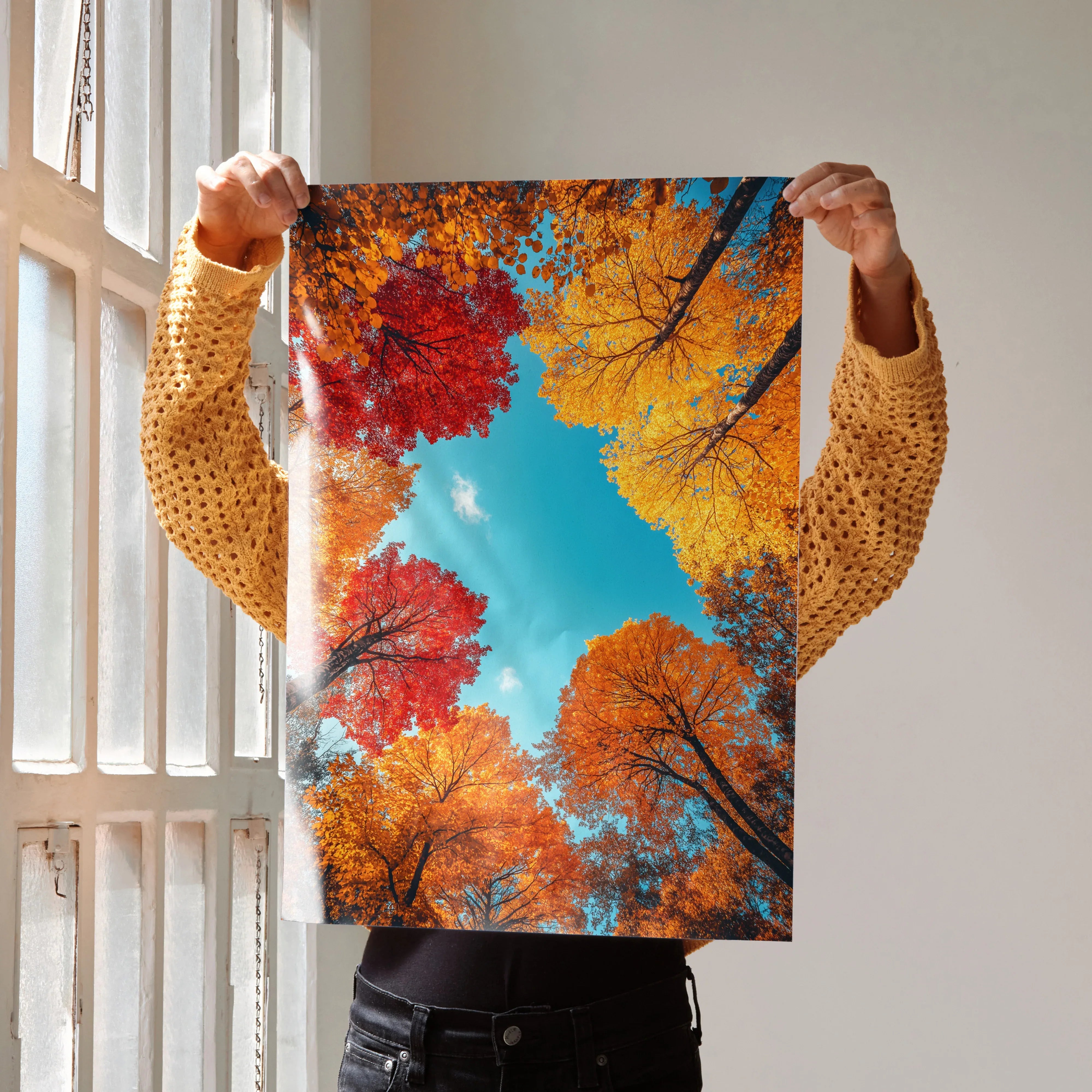 Vertical poster of vibrant autumn forest with red, orange, and yellow foliage against blue sky wall art.