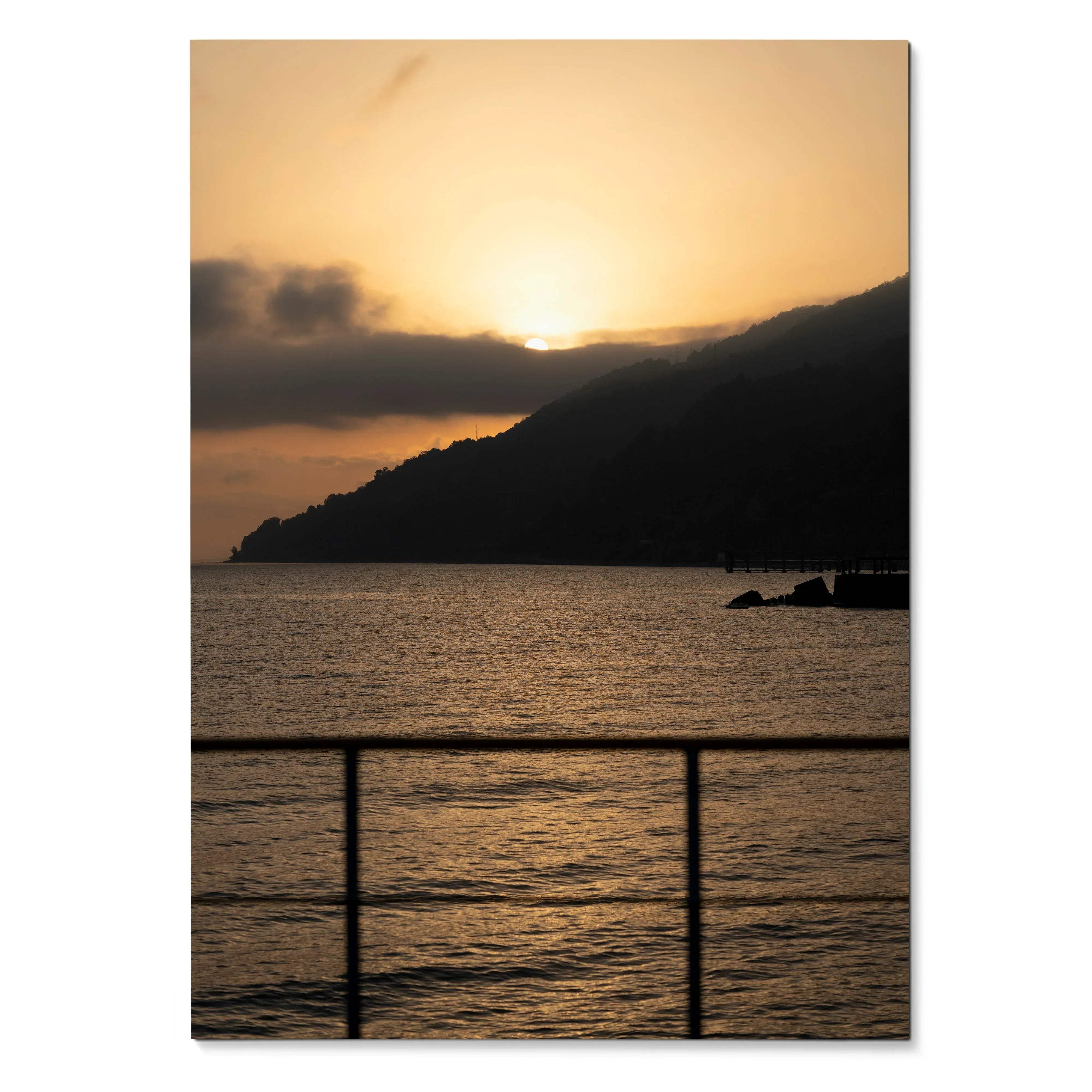 Vertical beach sunset poster showing sun setting behind dark hills over calm water wall art.