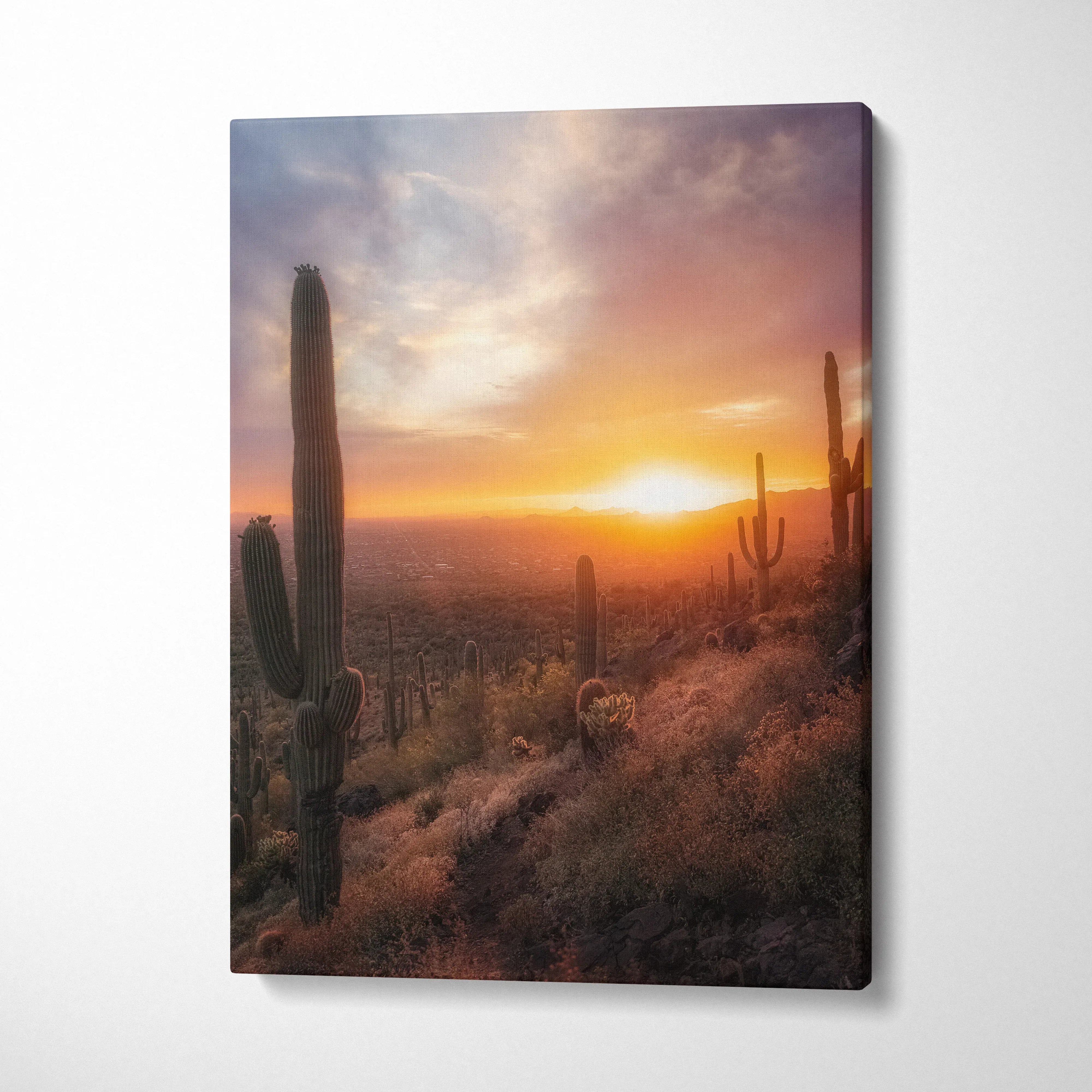Canvas wall art of vibrant desert sunset with silhouetted cacti and glowing sky.