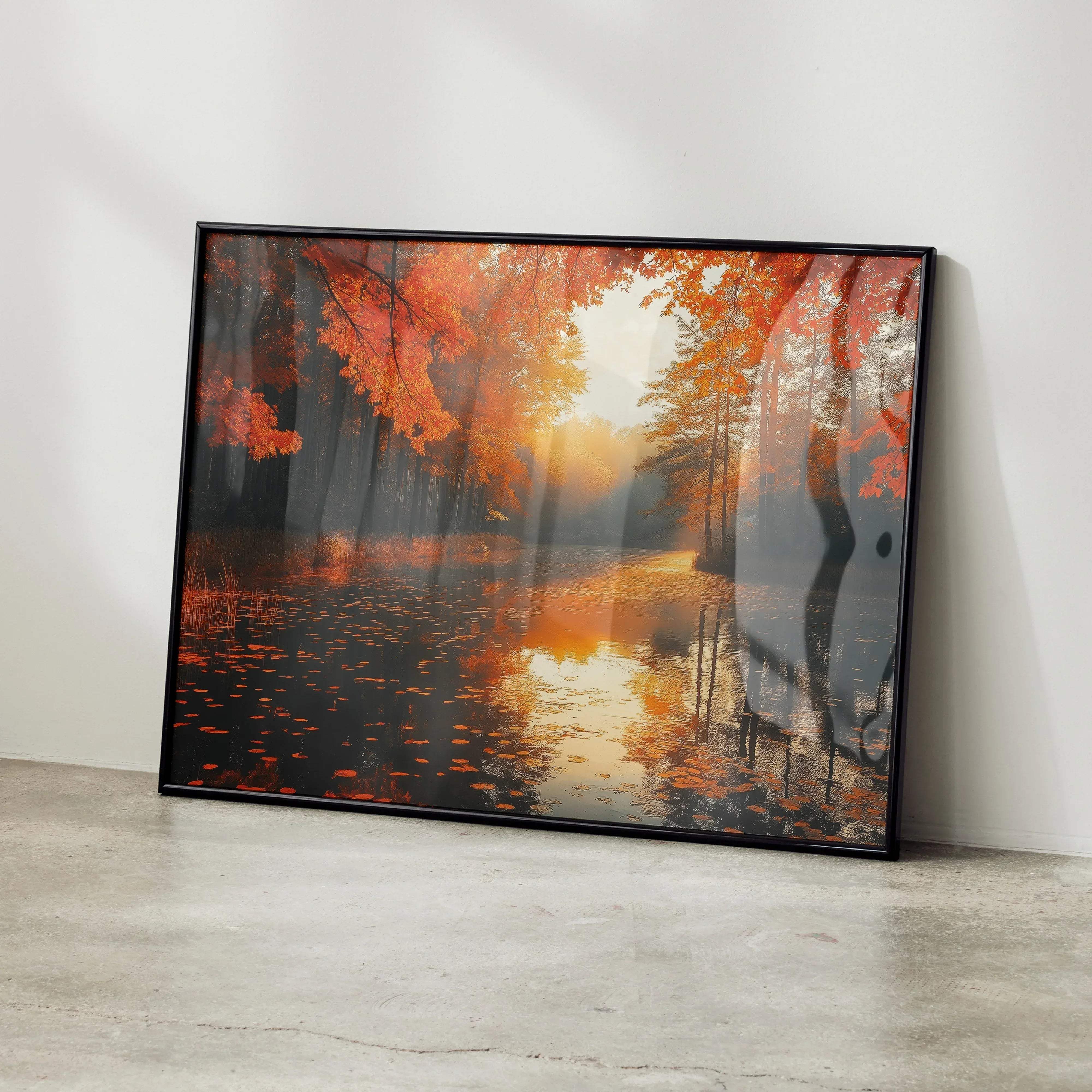 Black-framed canvas print of autumn forest digital art with vibrant orange and red foliage reflected in calm water