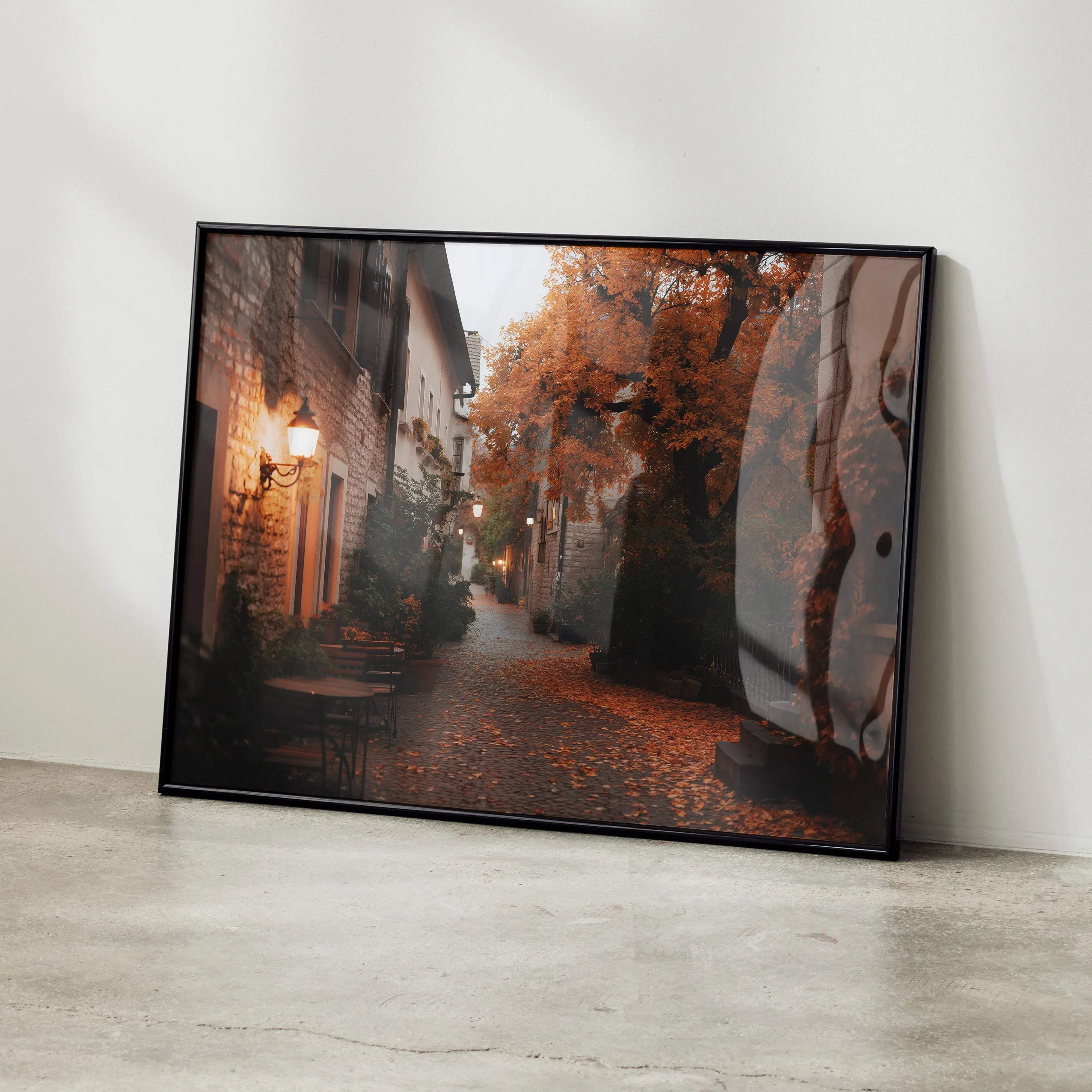 Black-framed canvas print of vibrant autumn nature digital art poster showing cobblestone alley with stone buildings and trees