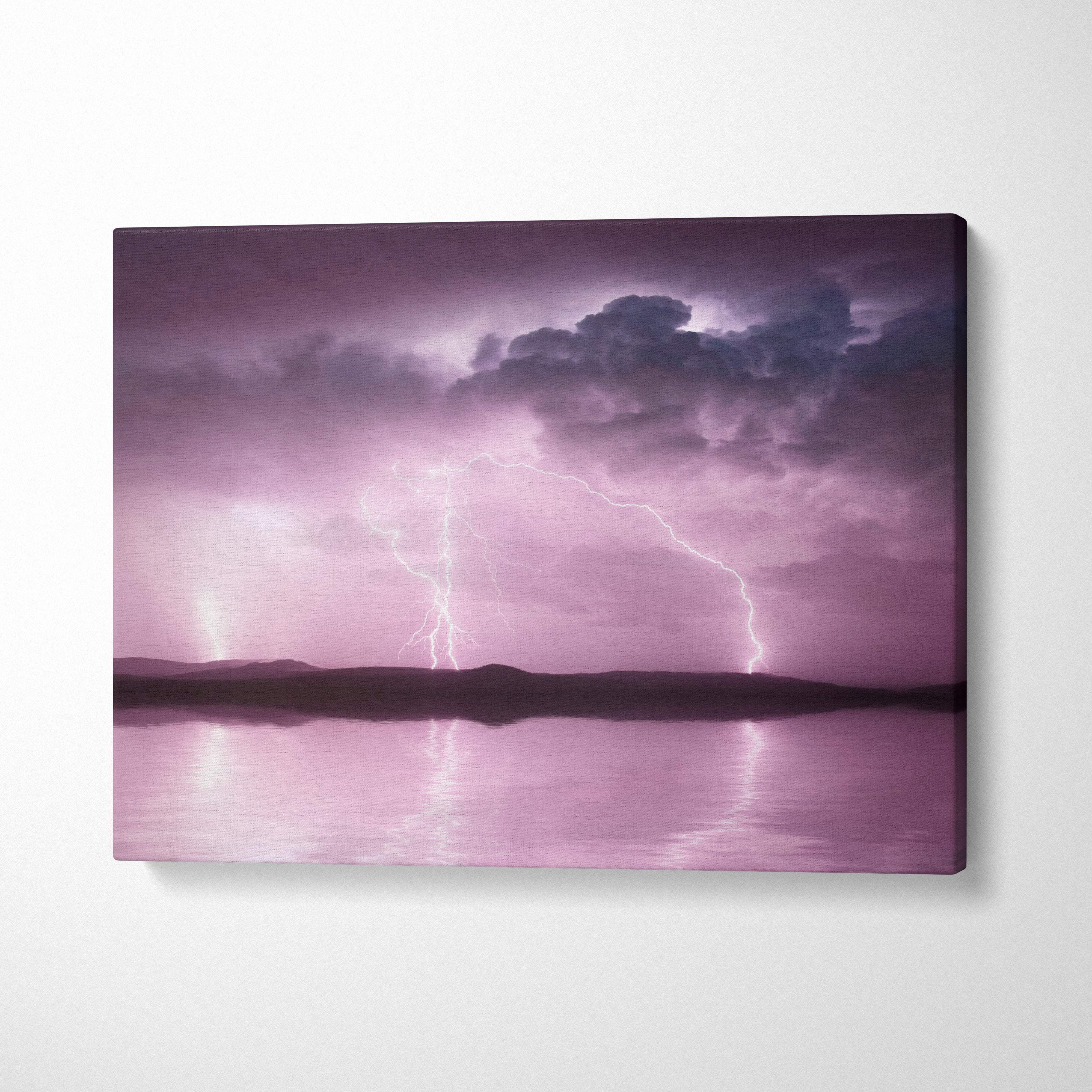 Pink lightning storm canvas art featuring a soft purple sky and lightning bolts reflecting on water for wall decor