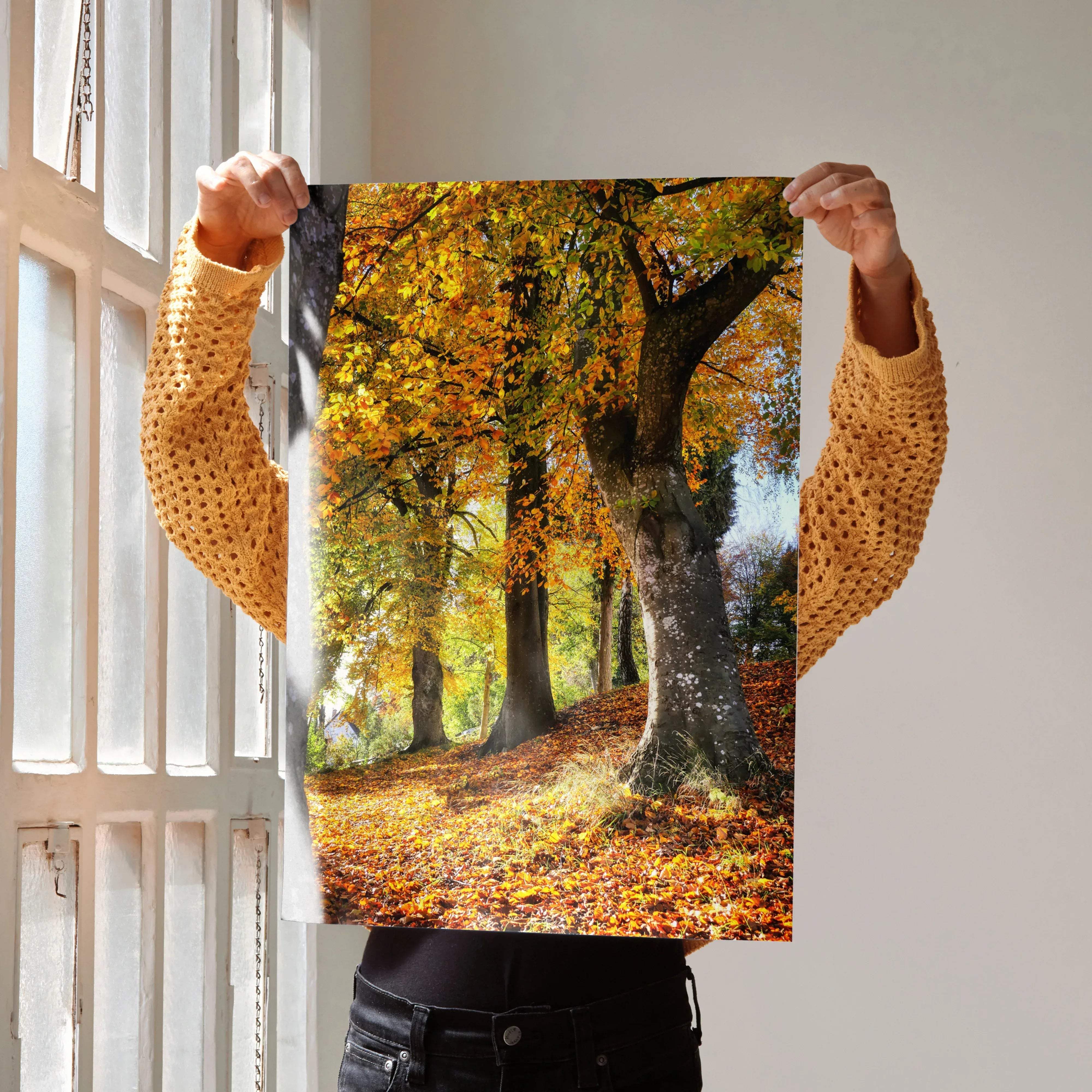 Serene autumn forest nature wall art poster featuring vibrant golden-yellow leaves and dark tree trunks on white wall
