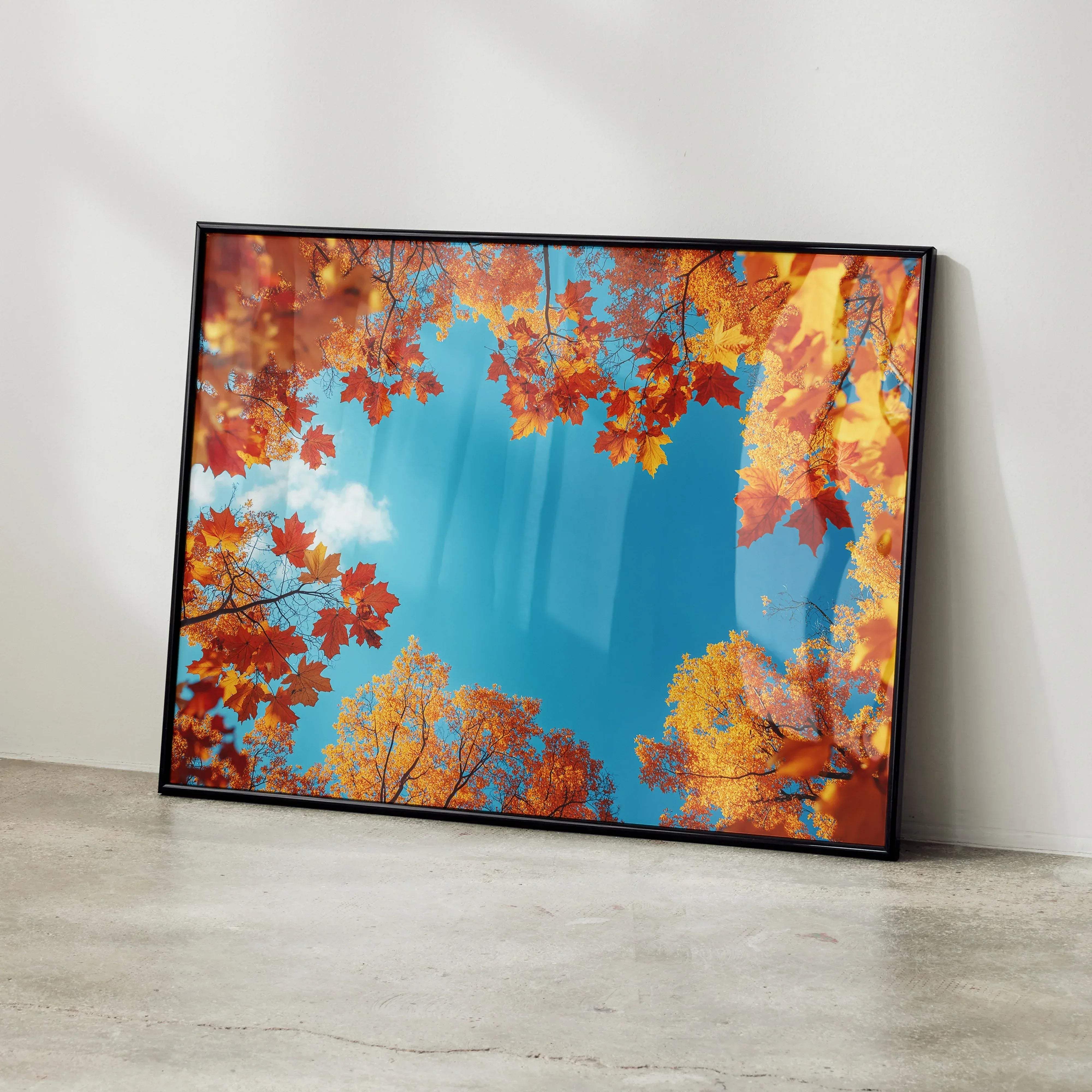 A framed autumn landscape digital art poster featuring vibrant orange and yellow leaves against a bright blue sky