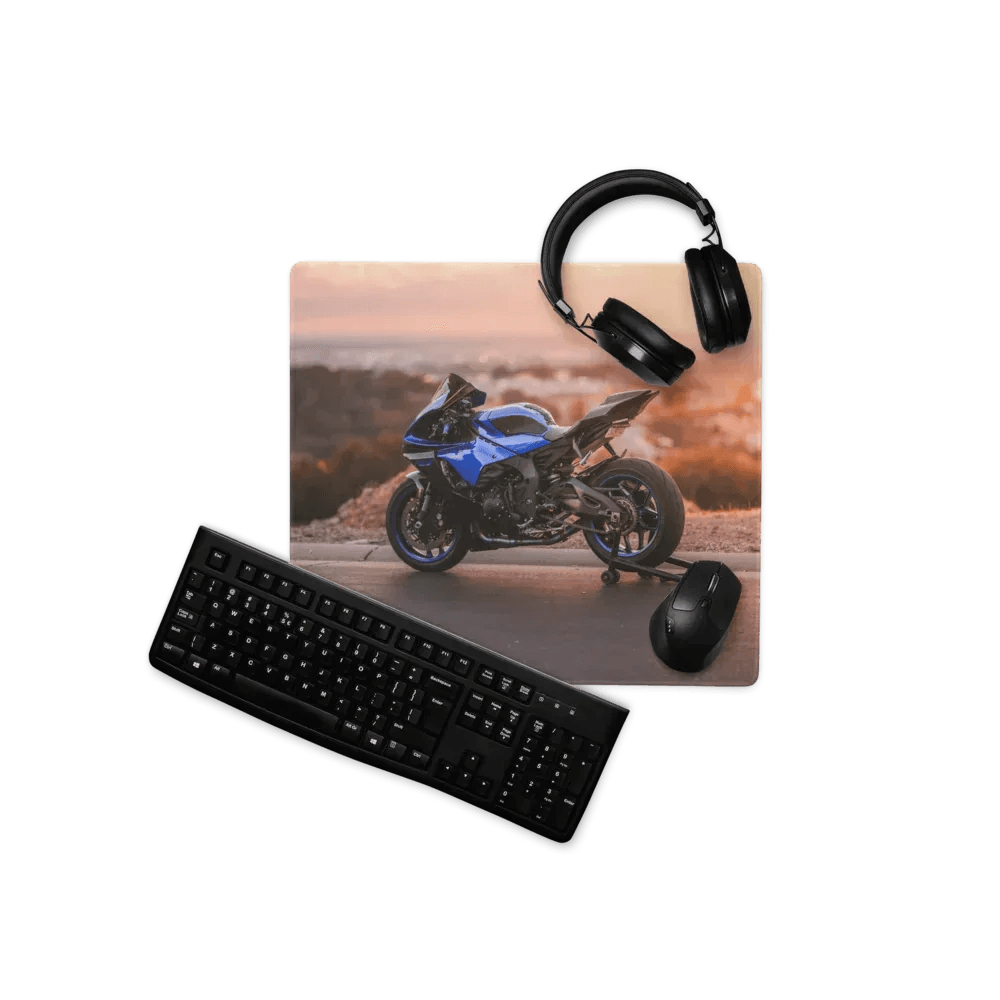 Blue Yamaha R1 large gaming mouse pad with sport motorcycle print arranged with black headphones and keyboard