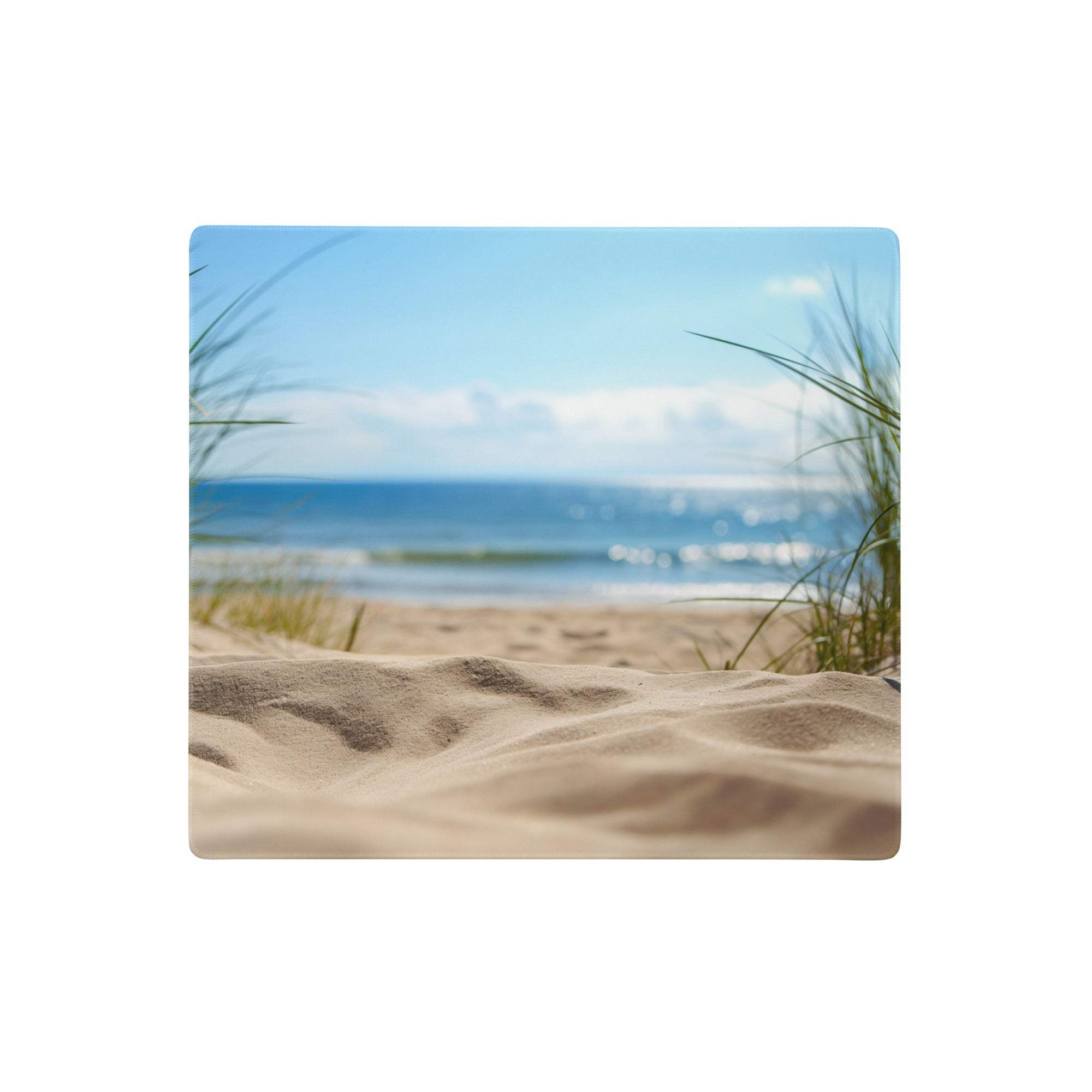 Coastal blue beach pad mouse pad with beige sand dune and green grass framing a blurred ocean view for gaming and desktop use