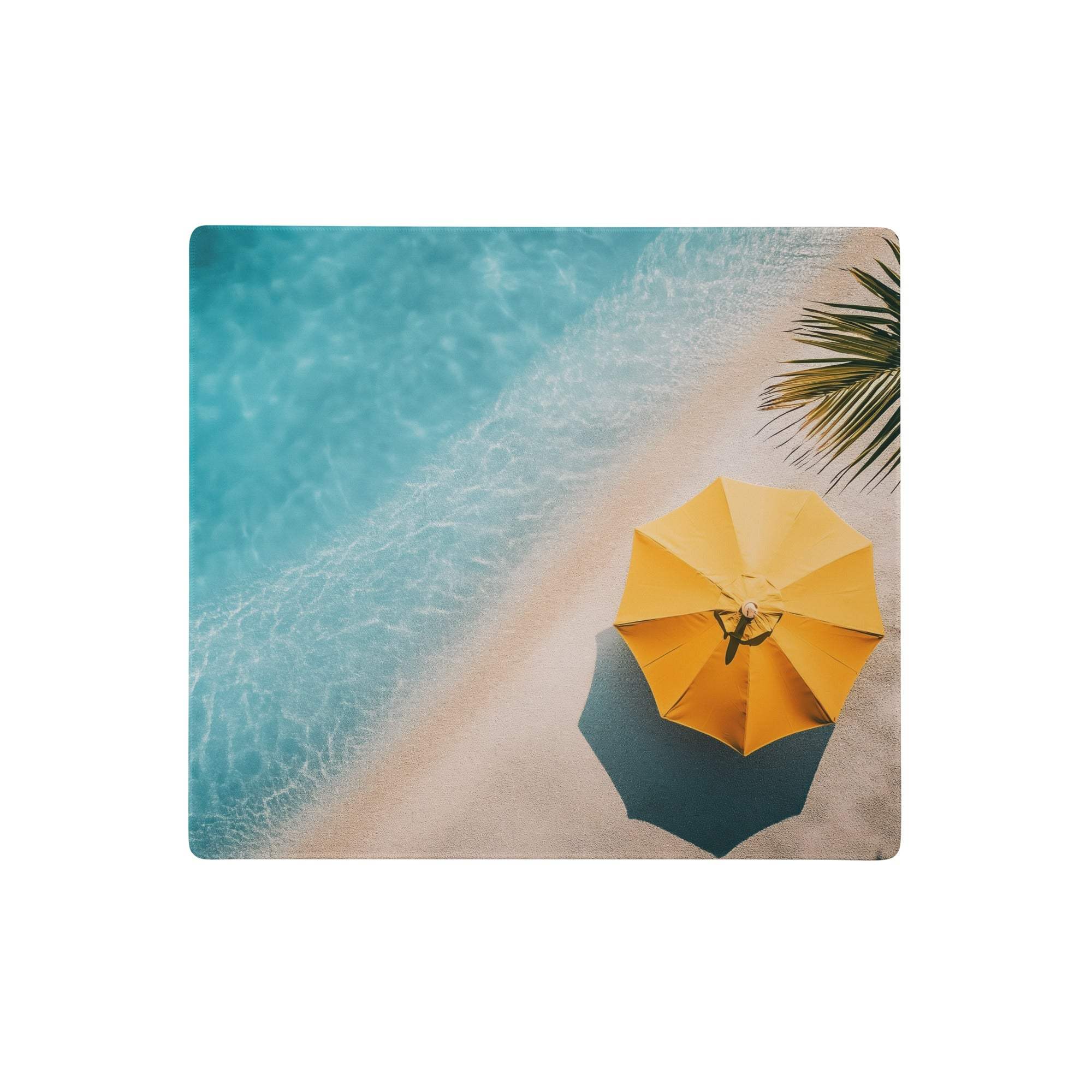 Bright yellow beach umbrella on sandy shore beside turquoise water on oceanic beach gaming pad with coastal print