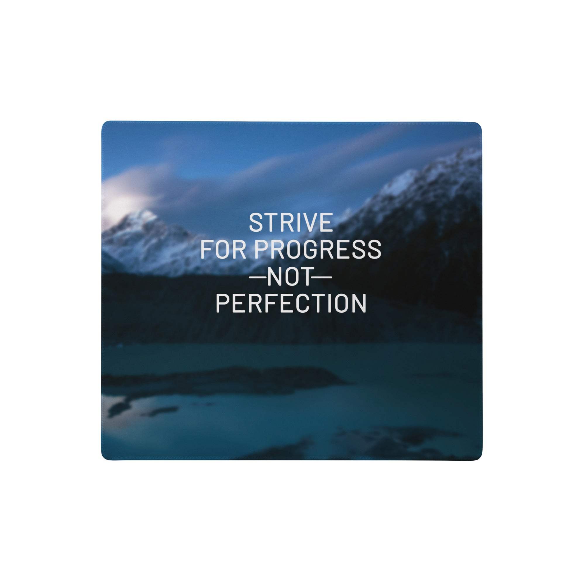 Blue rectangular mousepad with mountain landscape and motivational white text strive for progress not perfection