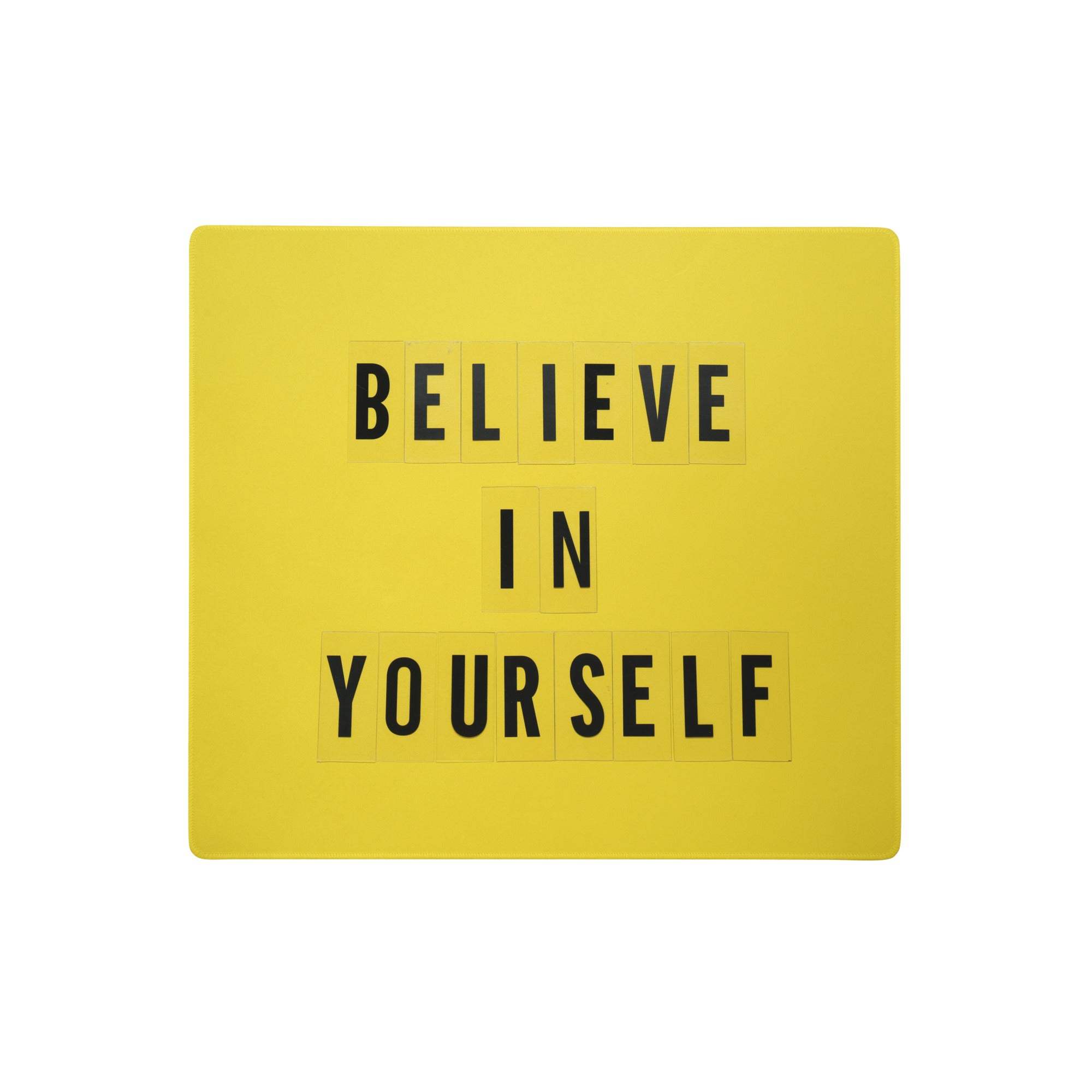 Bright yellow motivational mouse pad with black letter tiles spelling believe in yourself for office desk use