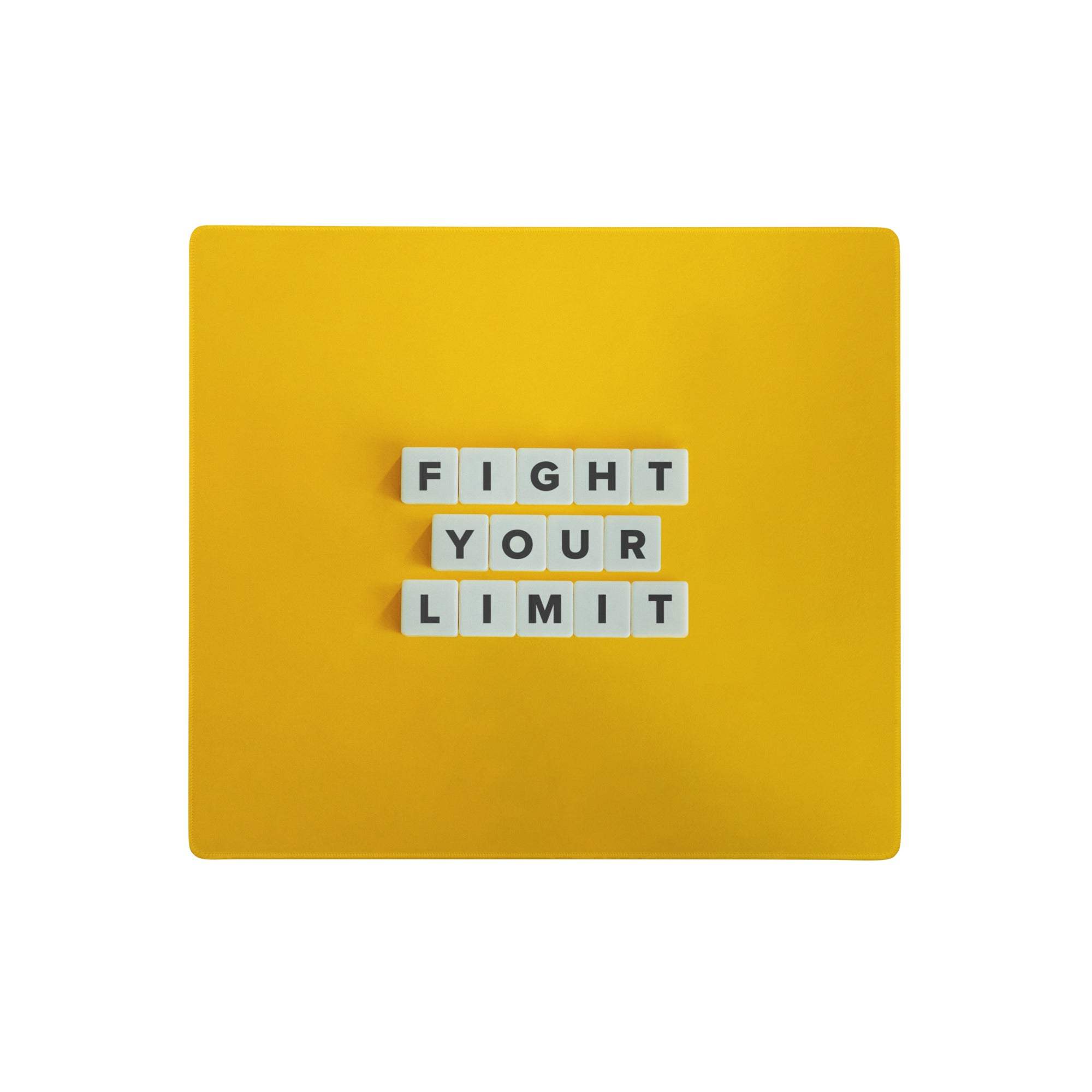Bright yellow motivational mouse pad with white letter tiles spelling fight your limit for modern office use
