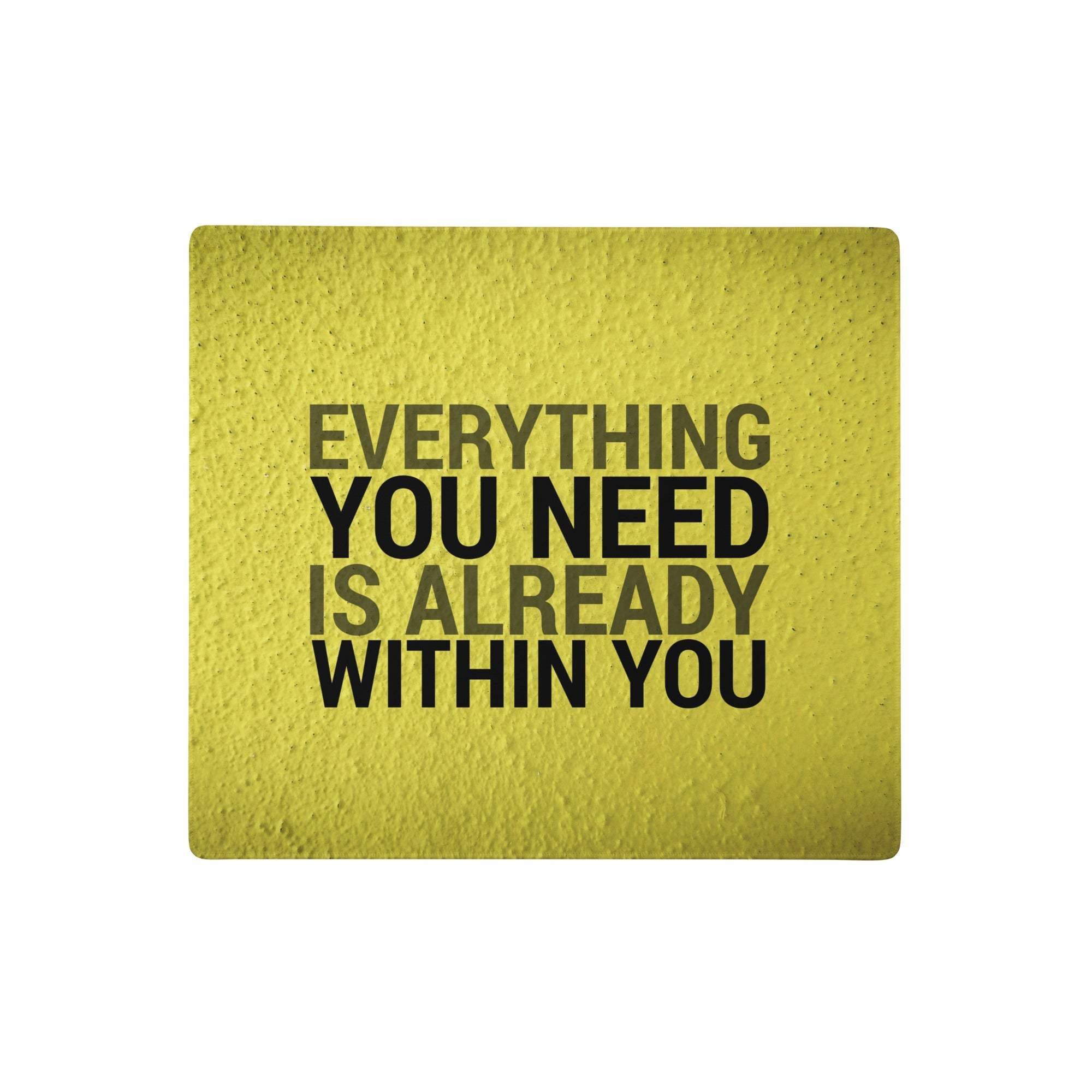 Yellow textured rectangular coaster with bold black and dark gray motivational typography on fabric surface