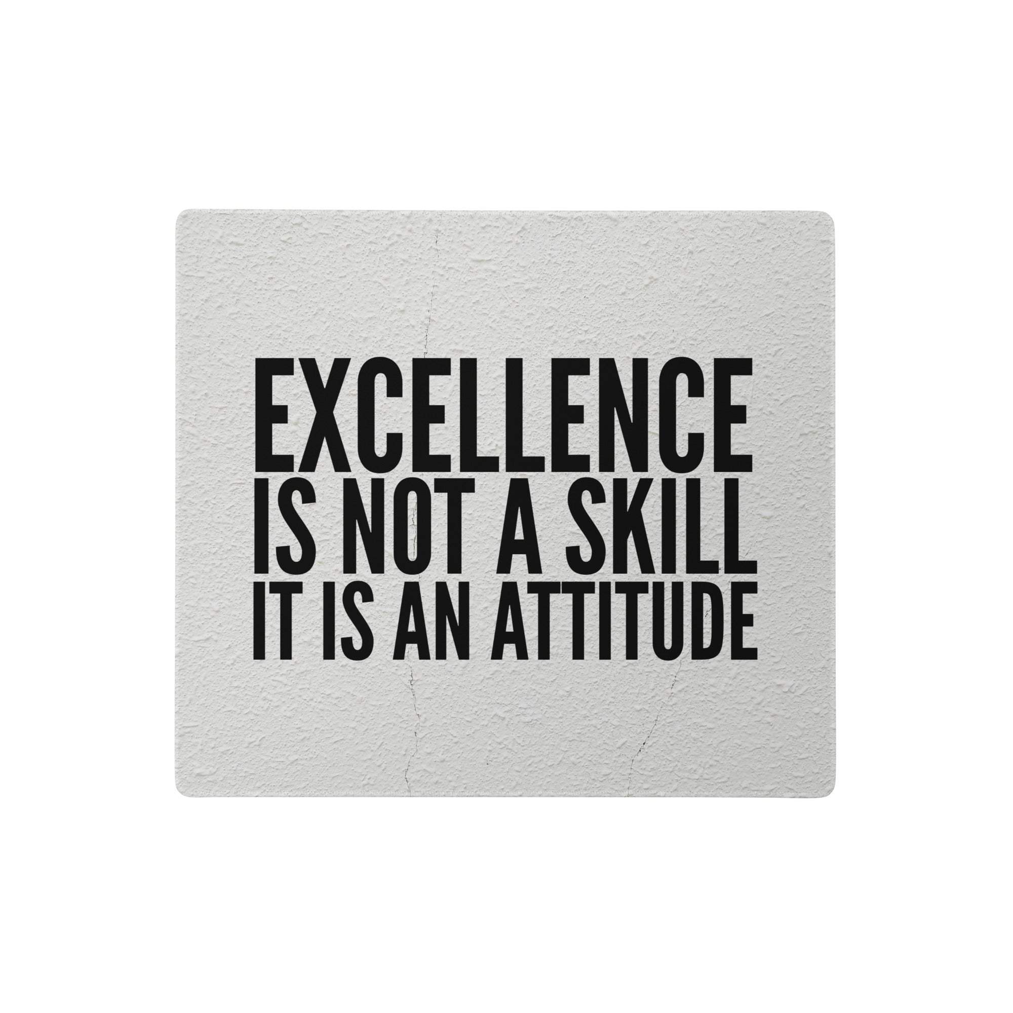 A rectangular textured gray fabric desk mouse pad with bold black motivational text excellence is not a skill it is an attitude