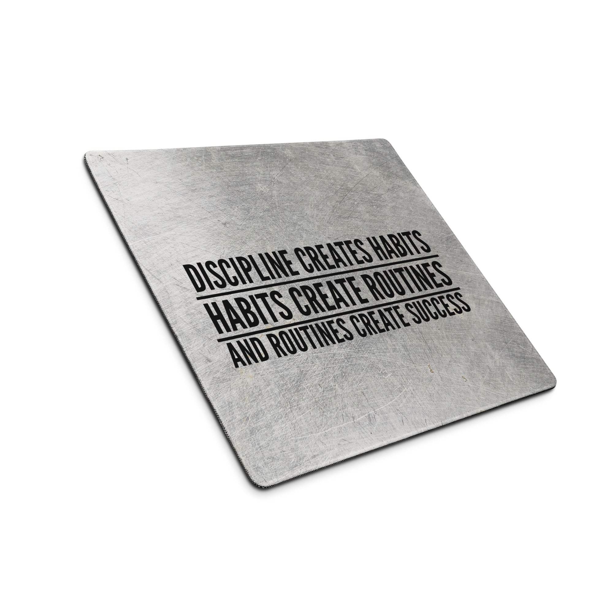 Silver metallic industrial motivational quote desk pad with black engraved discipline creates habits text for office use