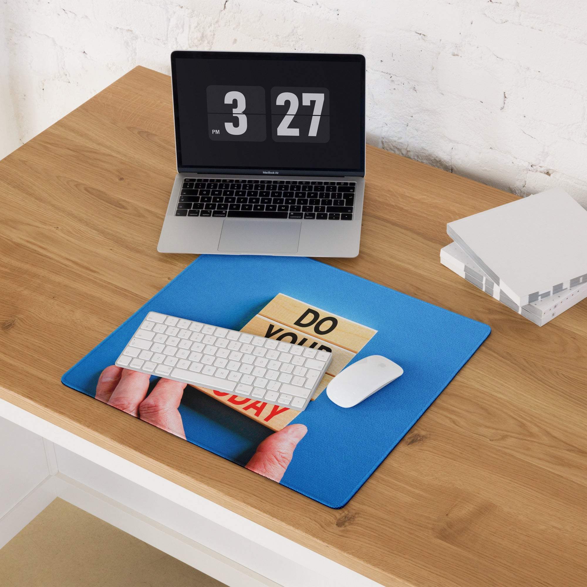 Blue motivational desk pad with do your day design holding wooden blocks and white keyboard for modern office use