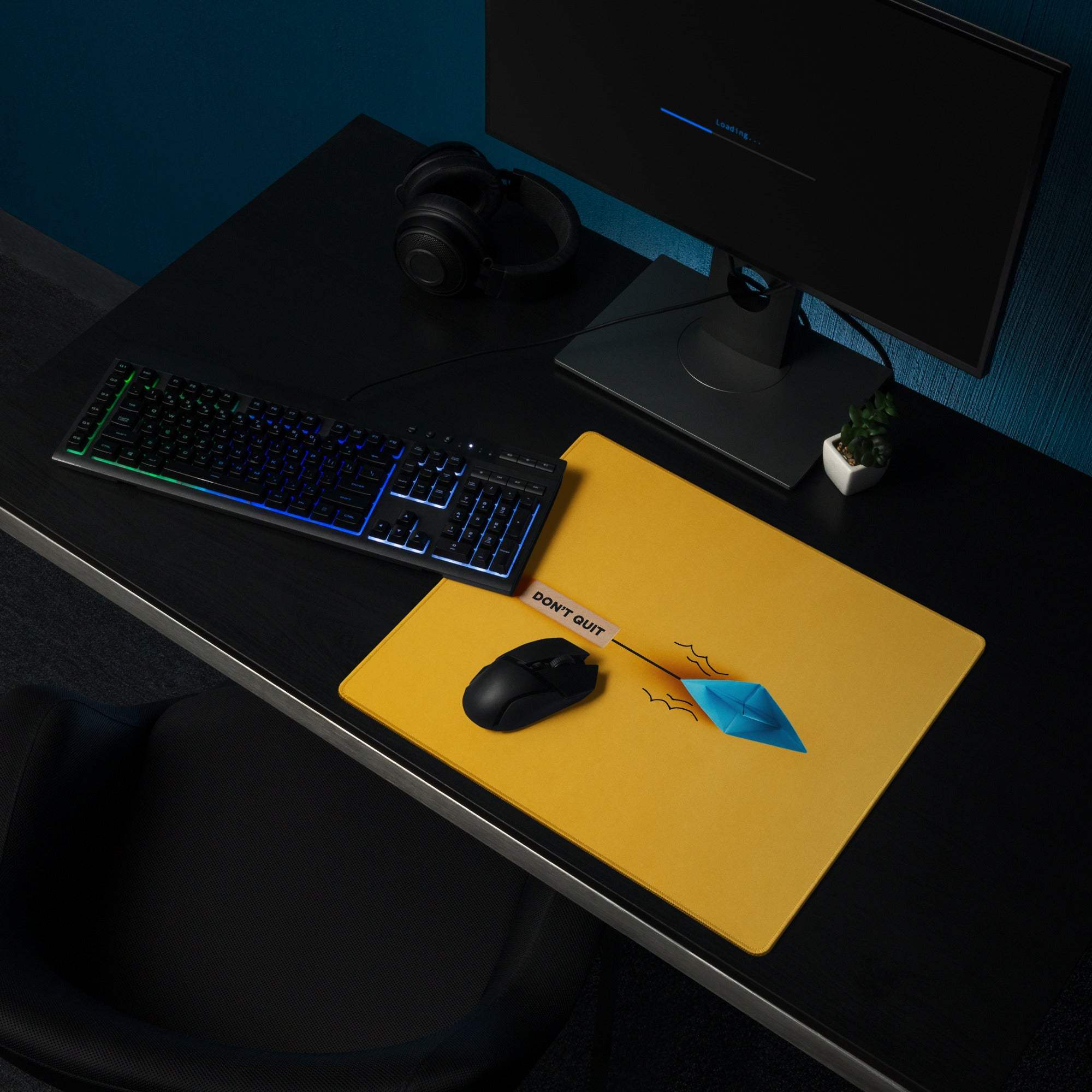 Yellow non slip mouse pad with a blue origami boat design and motivational dont quit text for modern office use